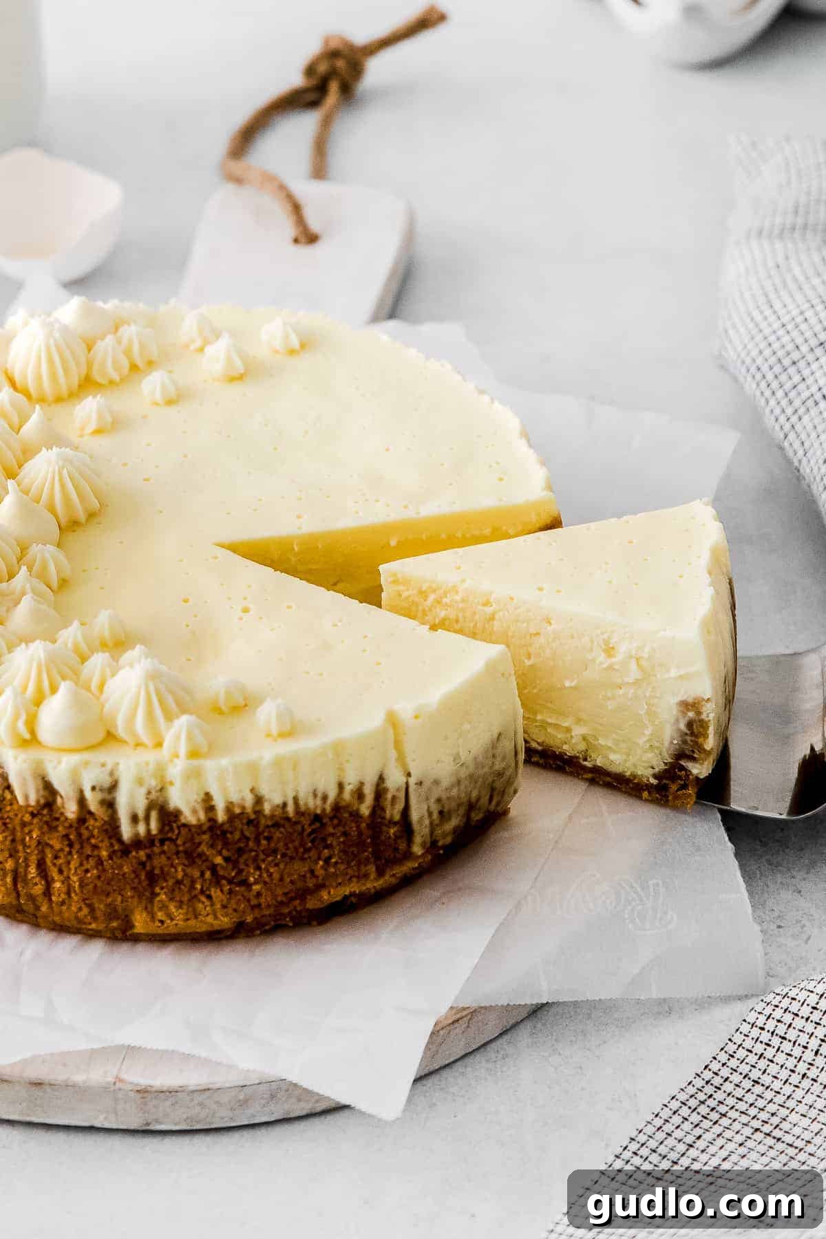 Creamy Dreamy Instant Pot Cheesecake: Effortless Perfection A perfect slice of creamy Instant Pot cheesecake being lifted from the full cake, ready to be served and enjoyed.