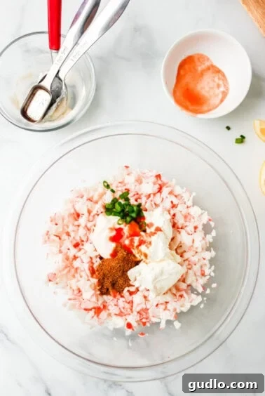 Cool & Creamy Crab Dip 8 A glass bowl filled with a mixture of salt, pepper and cold crab dip.