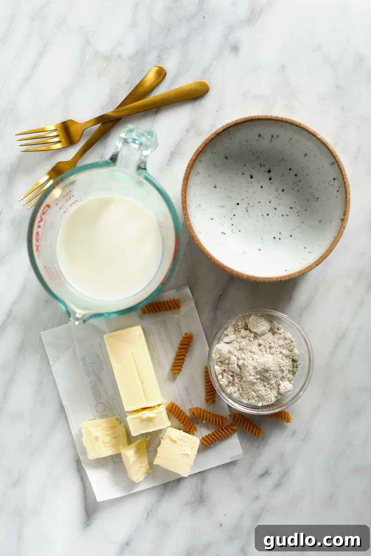 The Ultimate Gluten-Free Mac and Cheese 3 All the essential ingredients for making creamy gluten-free mac and cheese laid out on a kitchen counter.