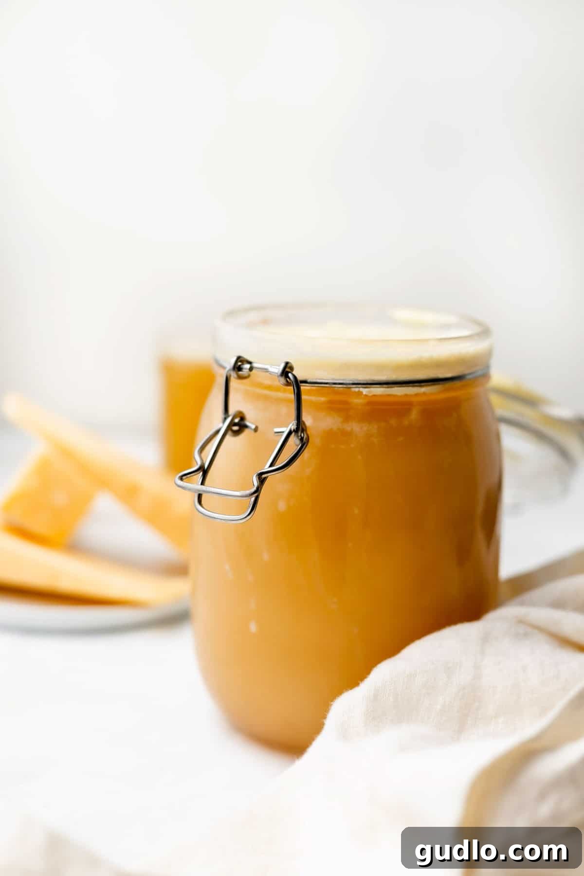 Rich Homemade Parmesan Broth Homemade parmesan broth in a glass jar, ready for use or storage.