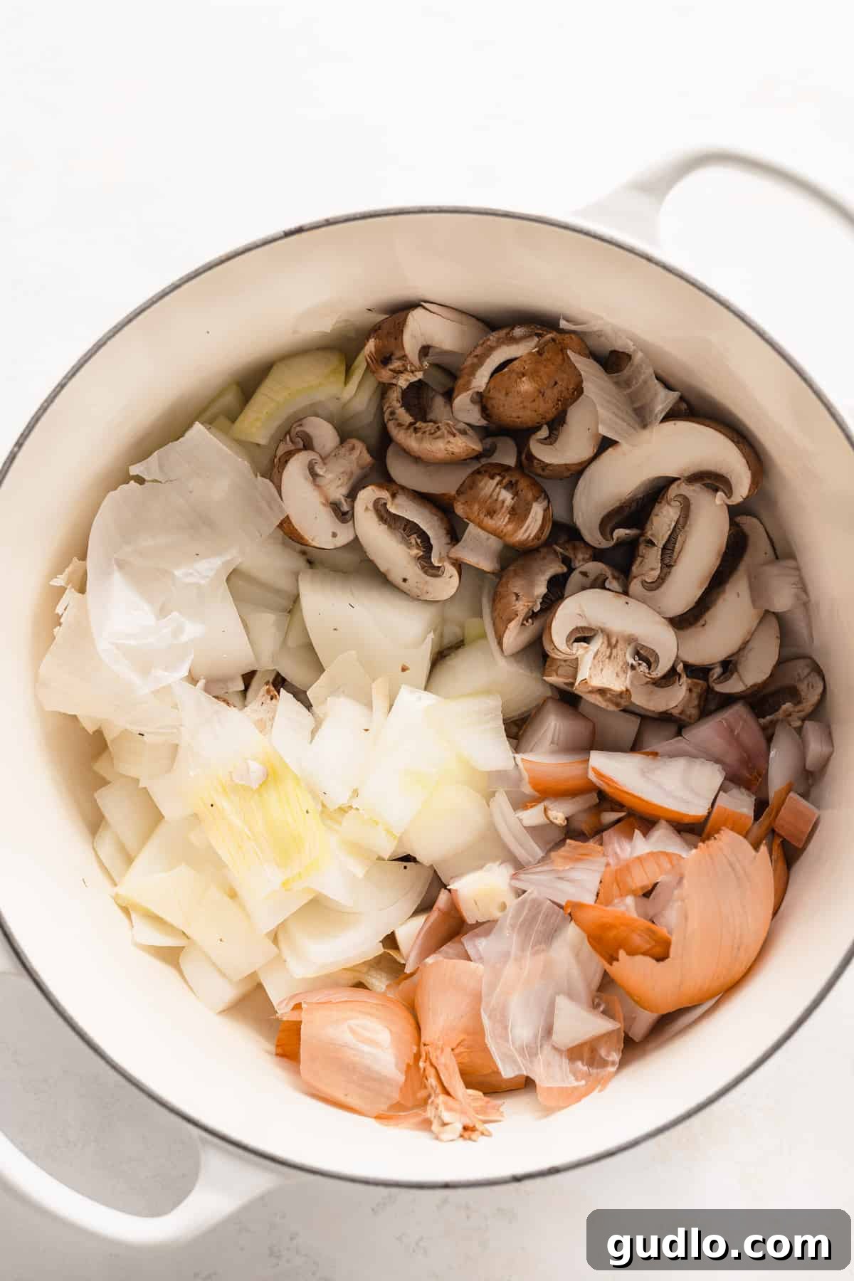 Parmesan Broth Simmering All the parmesan broth ingredients, including parmesan rinds, vegetables, and herbs, simmering together in a large stock pot, creating a flavorful base.
