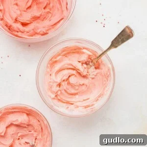 Sweetheart Cream Cheese Cookies 2 Bowls of creamy, colorful frosting, ready for cookie decoration.