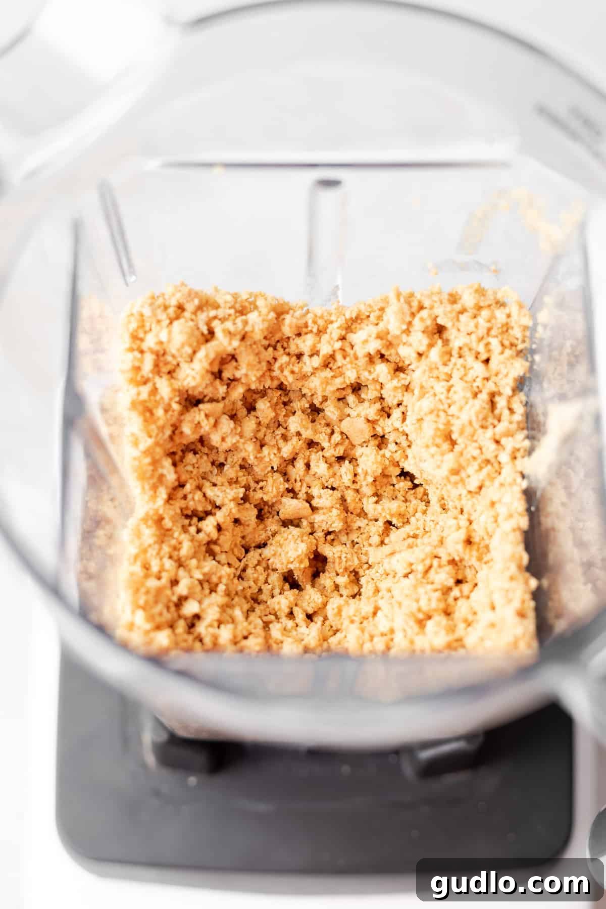 These pistachio pie cups are an individual size pistachio pie you'll absolutely LOVE! Made with a pistachio cheesecake filling and an easy graham cracker crust. Don't forget the dollop of whip on top! Graham cracker crust ingredients being blended in a food processor to crumbly perfection, ready for the pie cups.