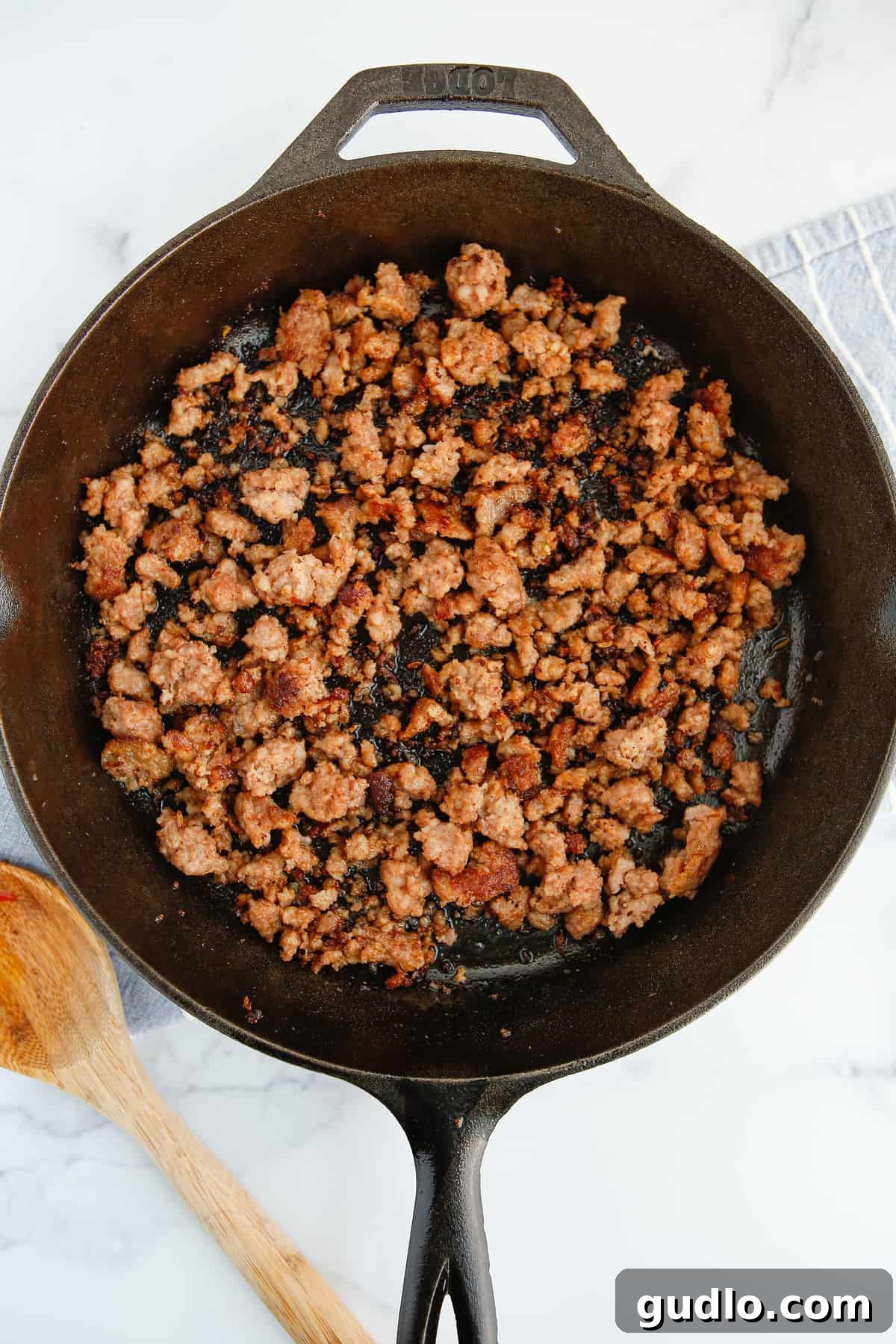 Sizzling Skillet Breakfast Potatoes 4 Ground Italian pork sausage browning in a cast iron skillet.