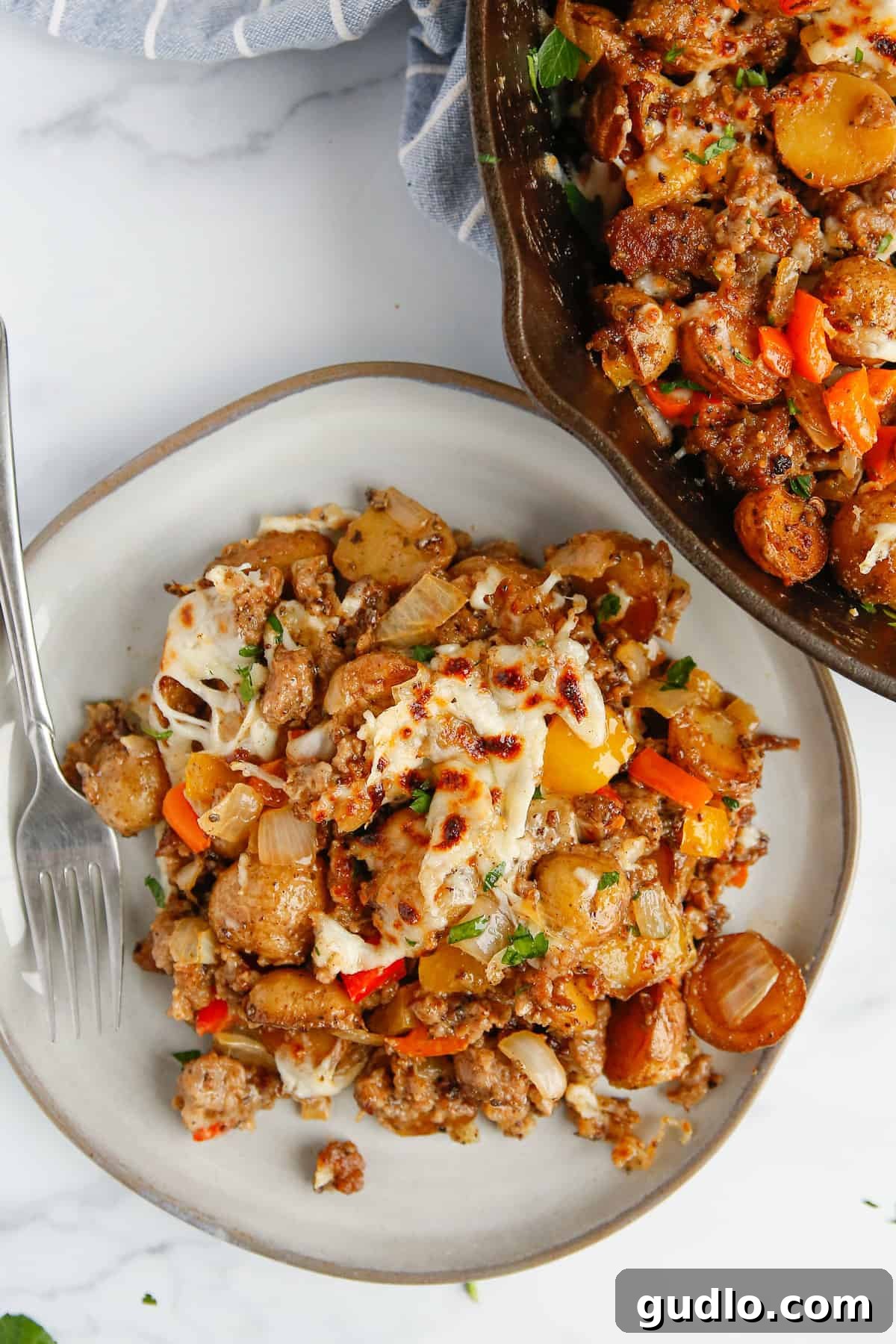 Sizzling Skillet Breakfast Potatoes 7 A generous serving of skillet breakfast potatoes on a plate with fresh parsley garnish.