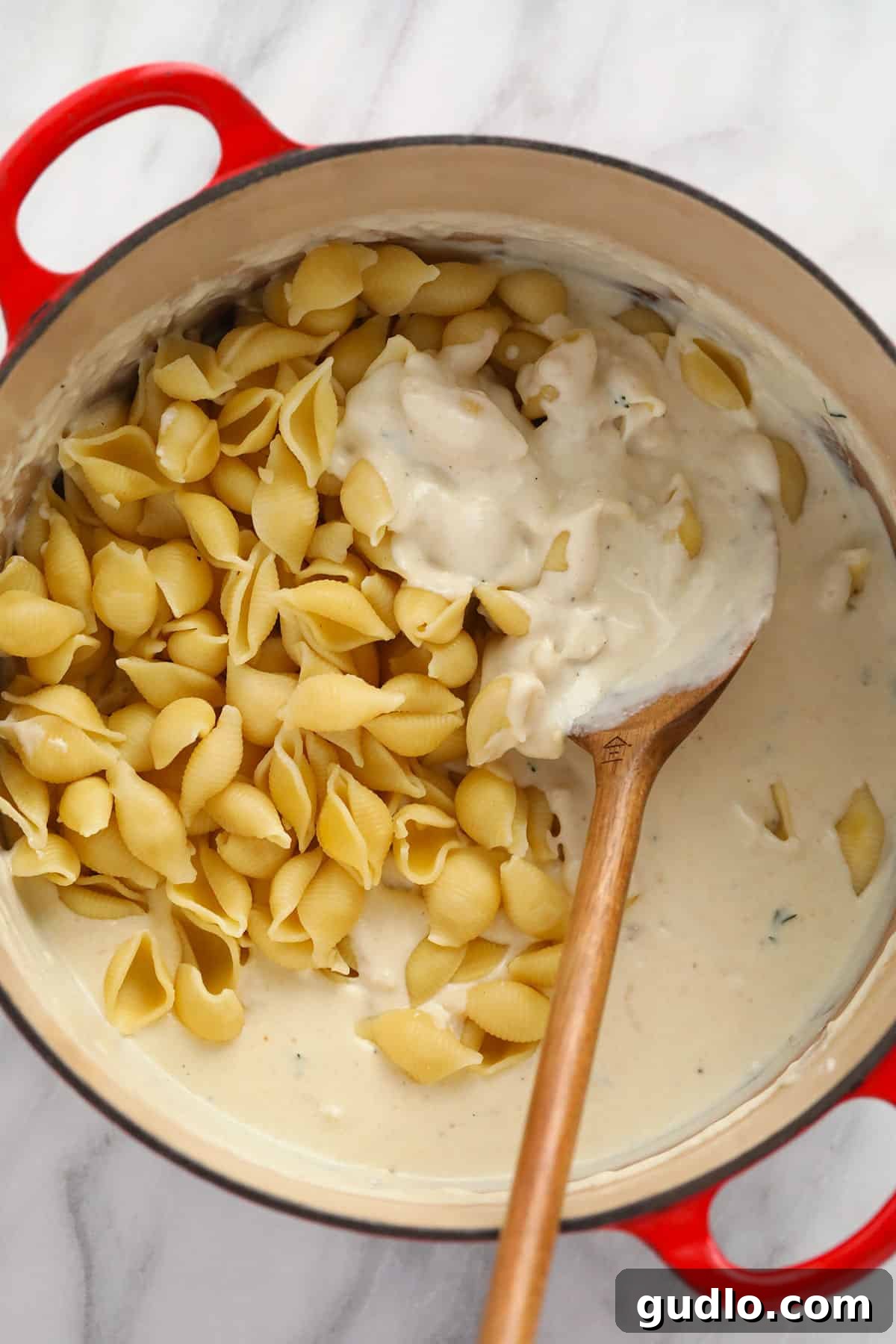 Cooked noodles perfectly coated in a creamy brie mac and cheese sauce.