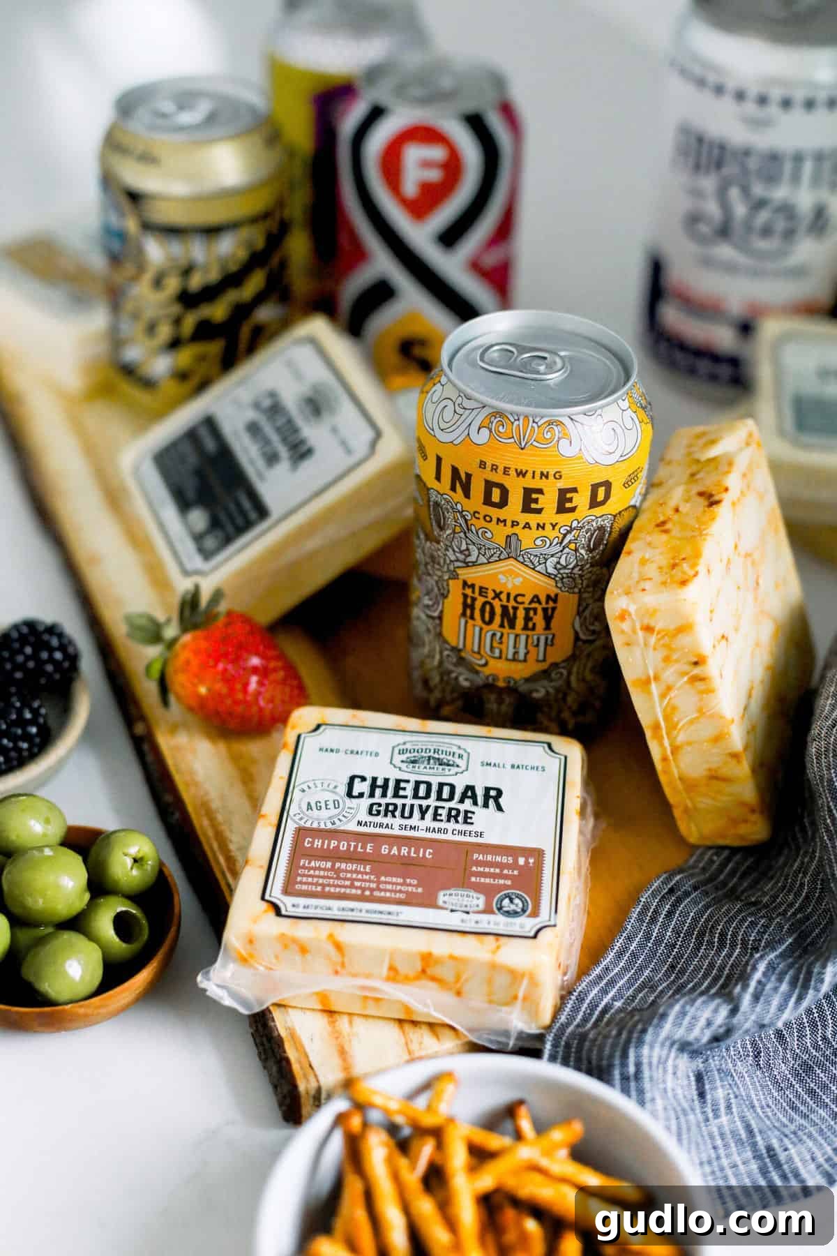 Expertly Paired Beer and Cheese: Wood River Creamery Meets Minnesota Craft Brews A beautiful spread of Wood River Creamery cheeses and Minnesota craft beers arranged on a rustic cutting board, ready for a tasting experience.