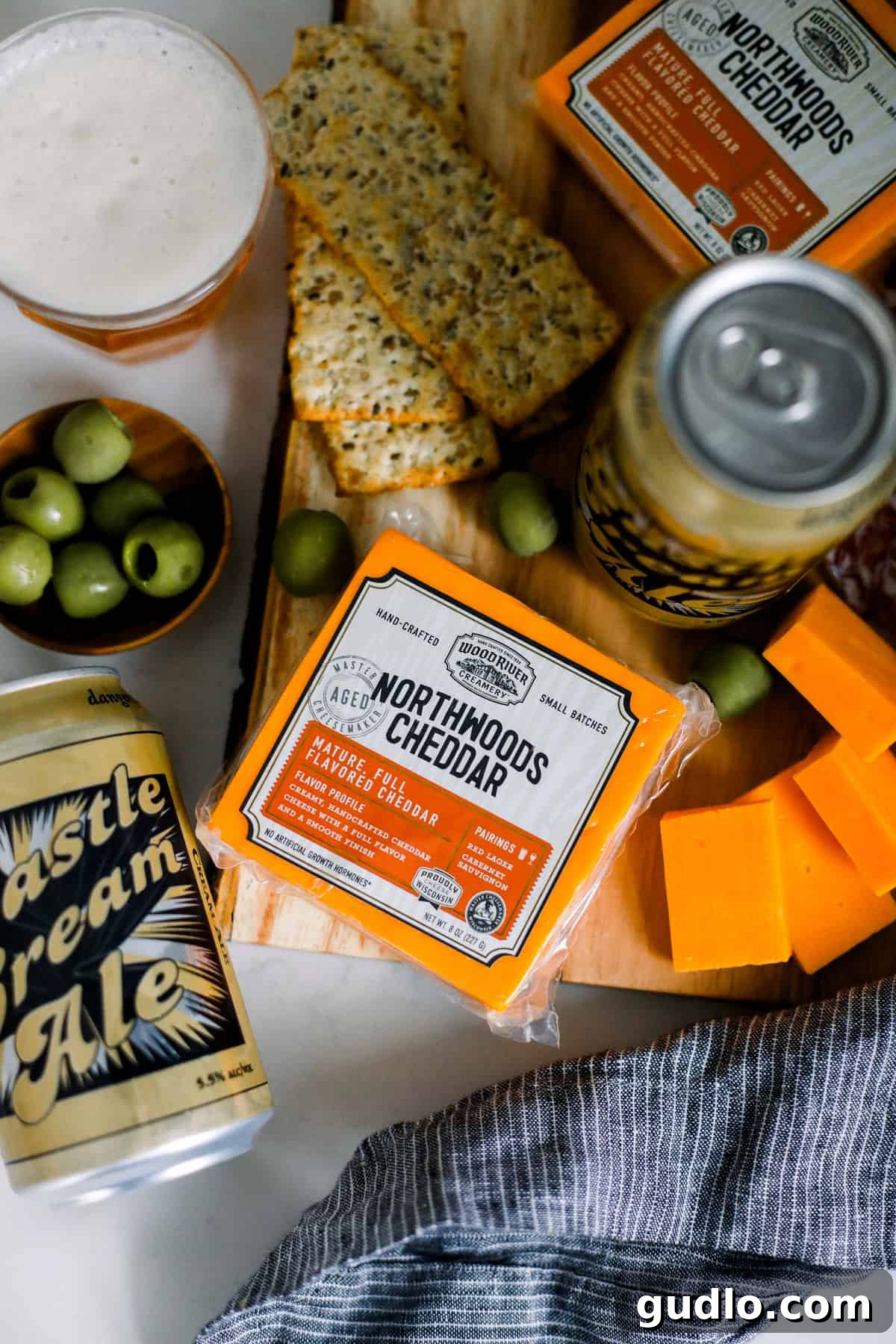 Creamy Cheddar & Refreshing Cream Ale: Northwoods Delight Wood River Creamery Northwoods Cheddar with salami and crackers, expertly paired with Castle Danger Castle Cream Ale.
