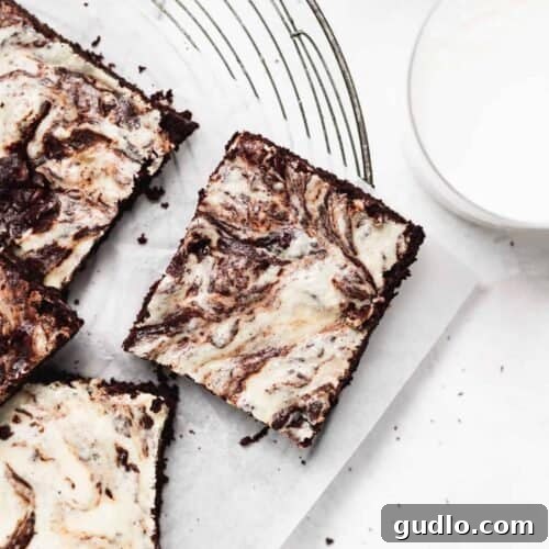 Cream cheese brownies on a cutting board, ready to be served.