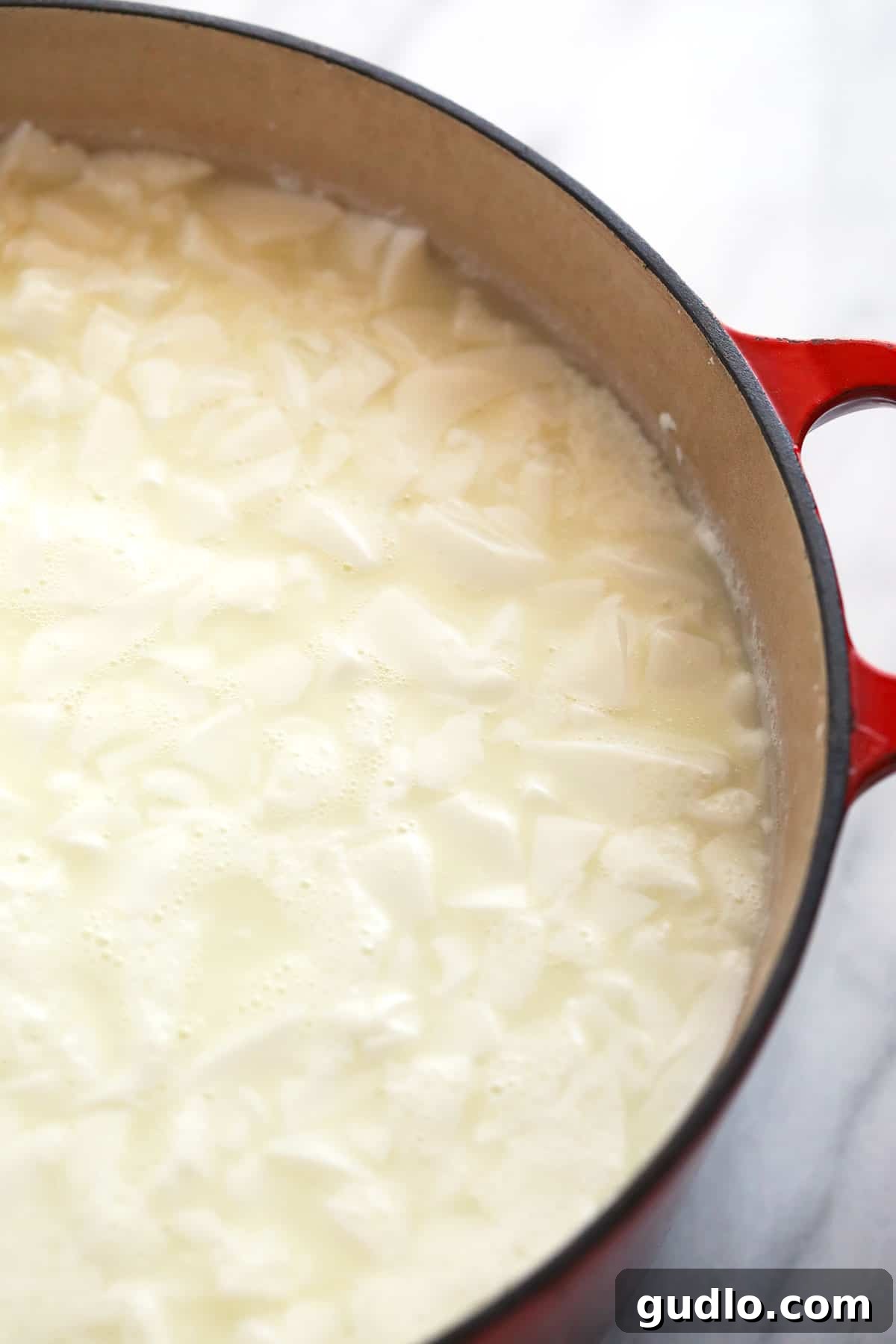 The Art of Making Queso Fresco at Home 6 Queso fresco curds settled at the bottom of a pot, separated from the whey.