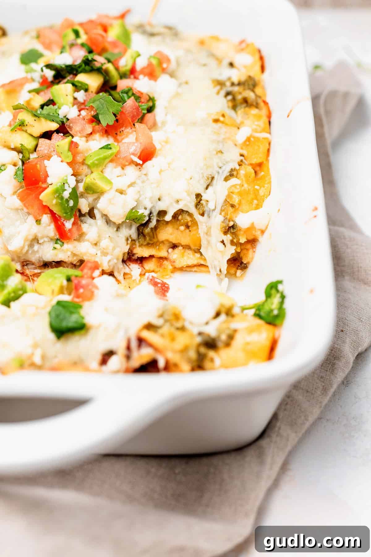 Comforting Homestyle Chicken Enchiladas 6 A large baking dish filled with savory, baked chicken enchiladas, golden-brown and bubbling hot from the oven.