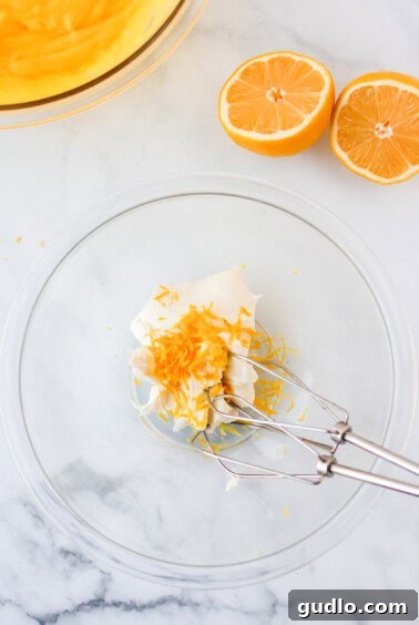 a glass bowl with orange slices and a fork.