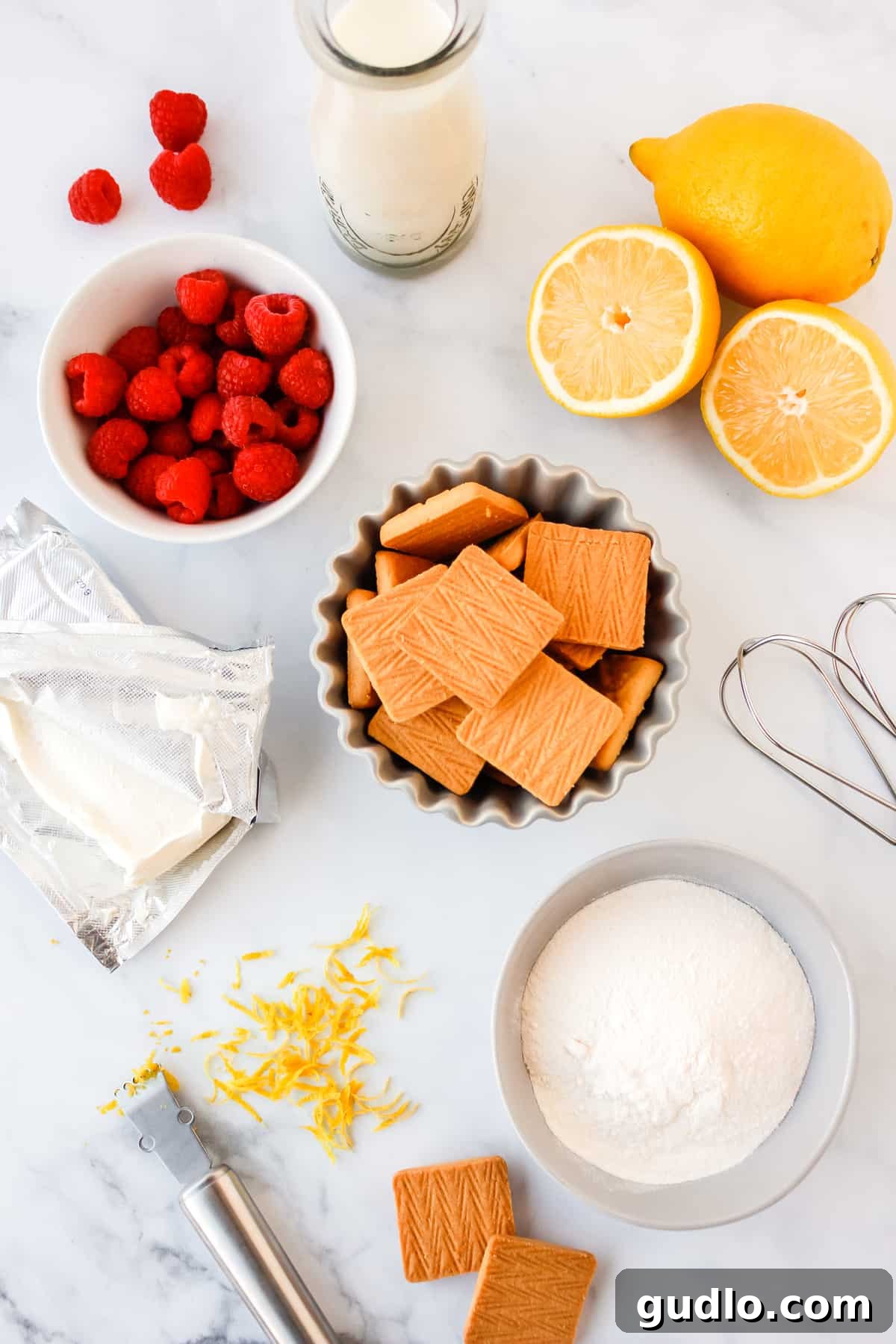 lemon cheesecake dessert ingredients laid out on a kitchen counter