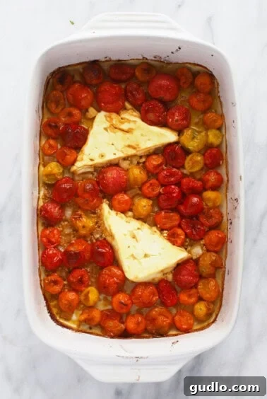 Roasted Feta Tomato Pasta Perfection 5 Baked feta and tomato sauce being mashed and mixed in the casserole dish.