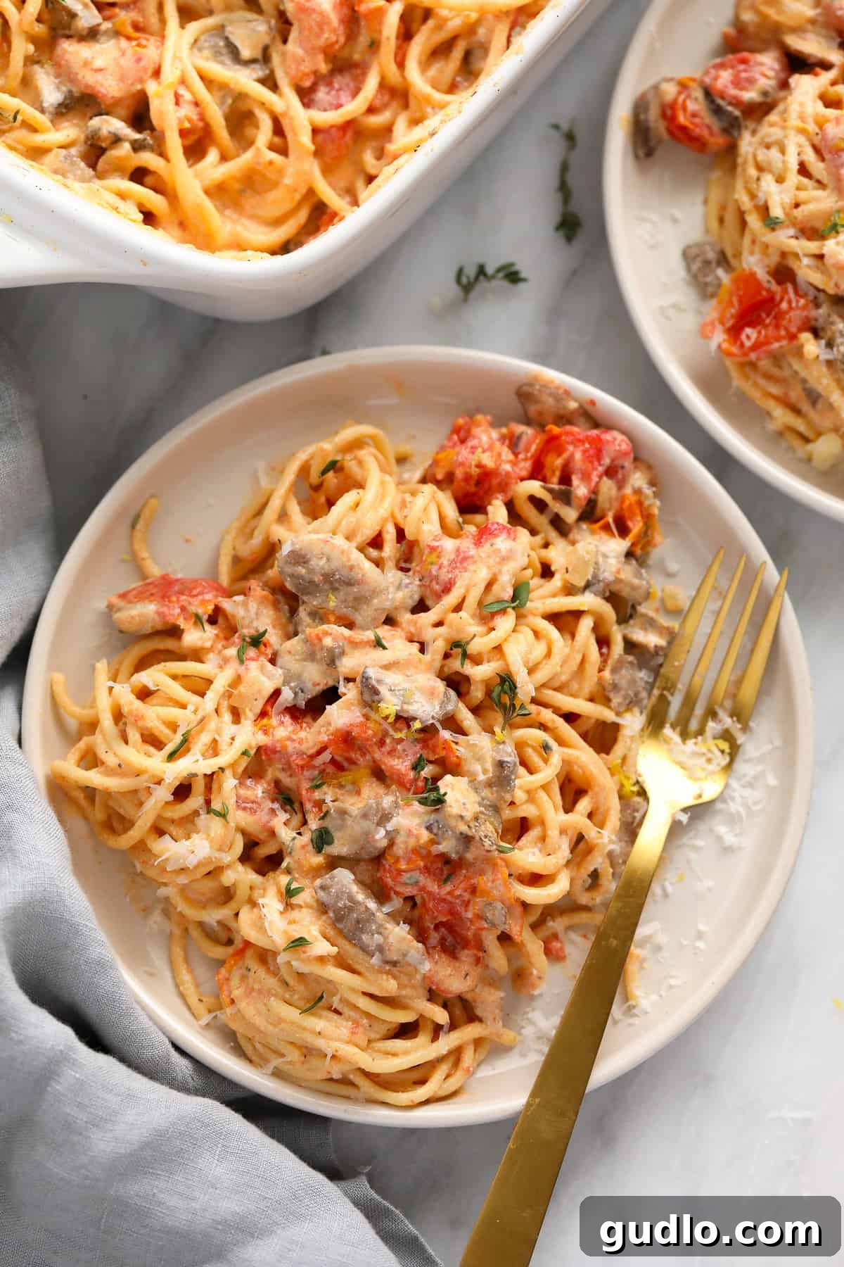 Delicious Baked Cream Cheese Pasta Ready to Enjoy A beautifully presented plate of baked cream cheese pasta, showcasing creamy sauce, vibrant tomatoes, and tender spaghetti, ready to be served.