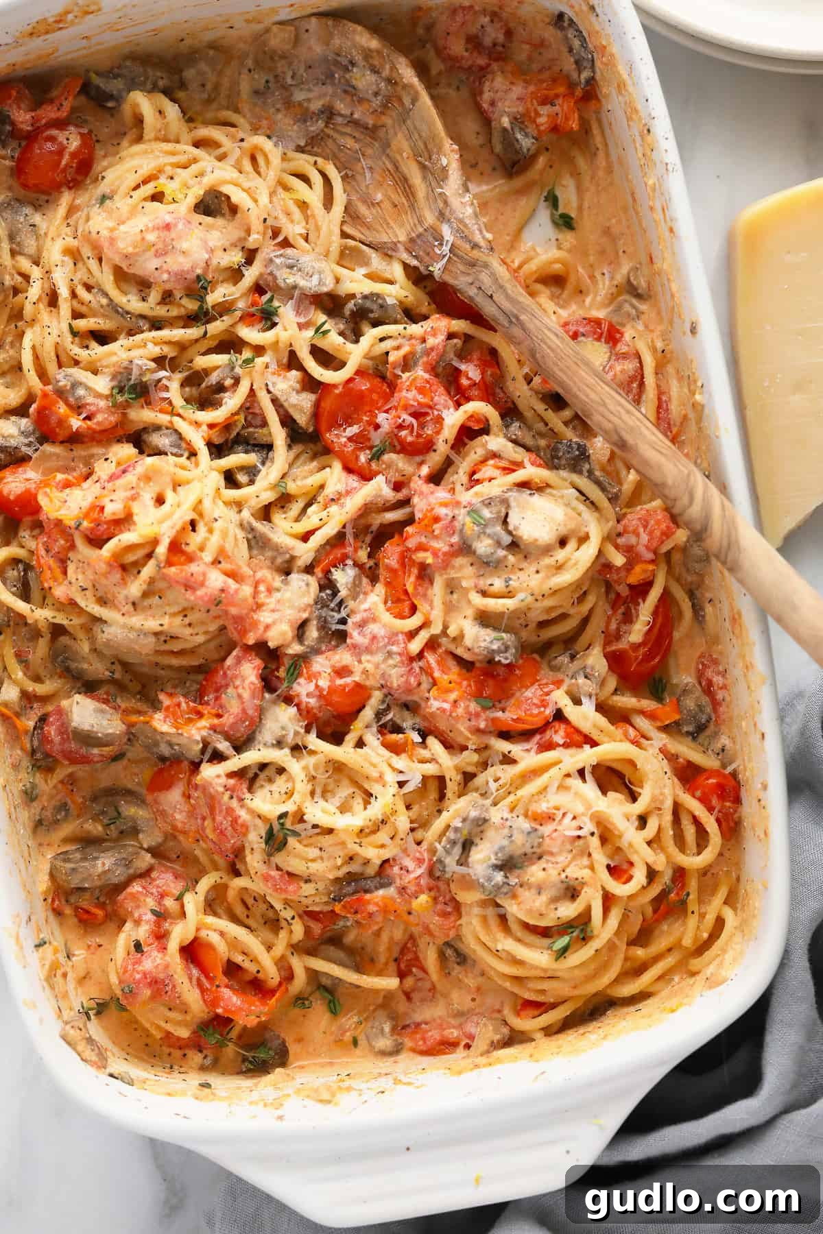 Baked Cream Cheese Pasta Ready to Serve The finished baked cream cheese pasta, perfectly tossed with spaghetti in the casserole dish, garnished with fresh herbs, and ready to be served hot.