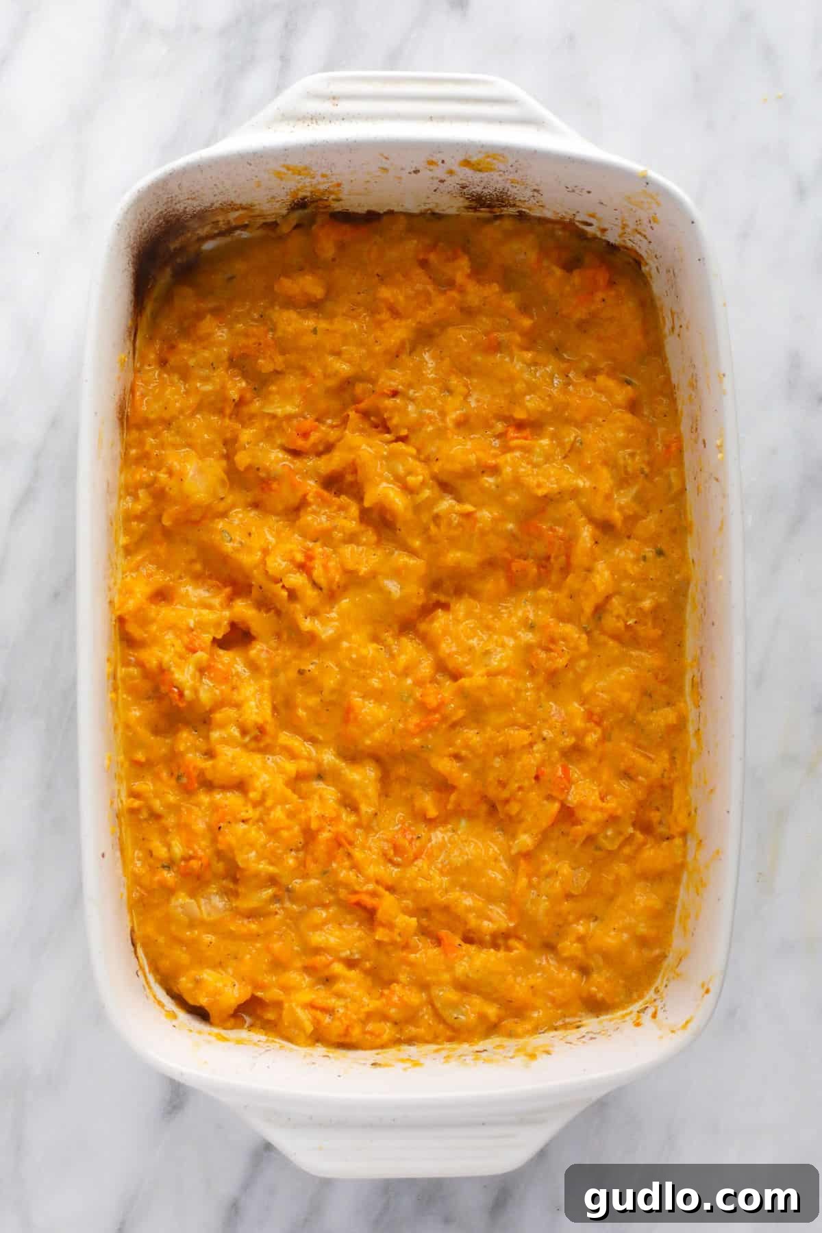 Velvety Butternut Squash Boursin Sauce Rich butternut squash and Boursin cheese pasta sauce in a casserole dish, ready for pasta