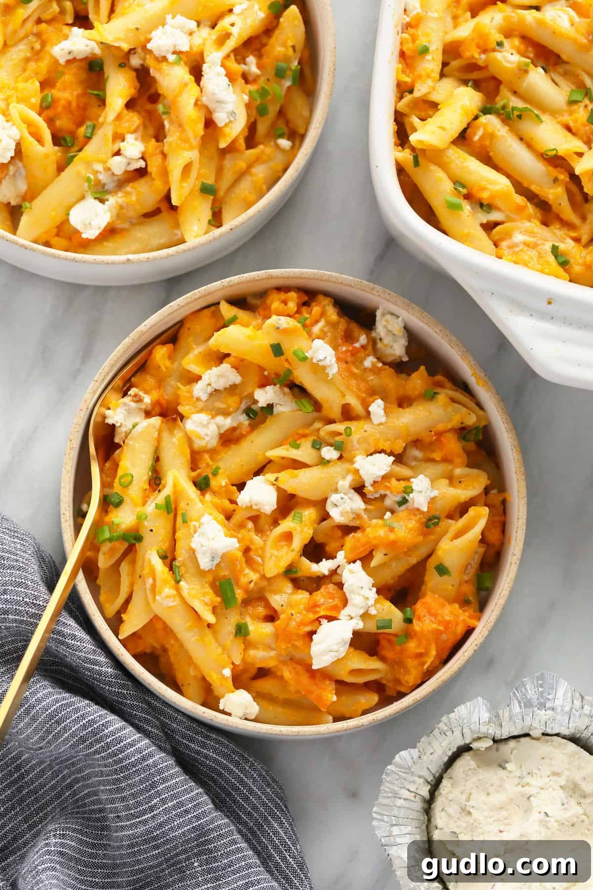 Butternut Squash Pasta Serving A serving of creamy butternut squash pasta, garnished with fresh herbs, in a bowl
