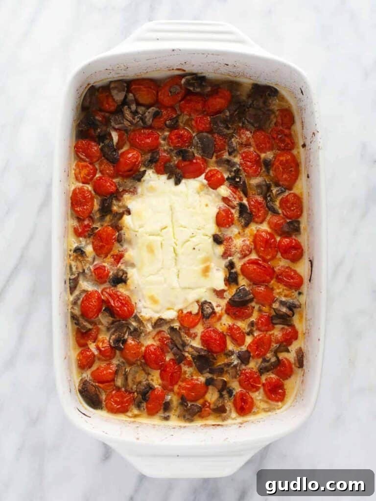 TikTok's Ultimate Cheesy Baked Pasta Craze 3 A delicious baked cream cheese pasta dish with tomatoes, mushrooms, onions, and fresh lemon juice, served with spaghetti, perfect for a flavorful dinner.