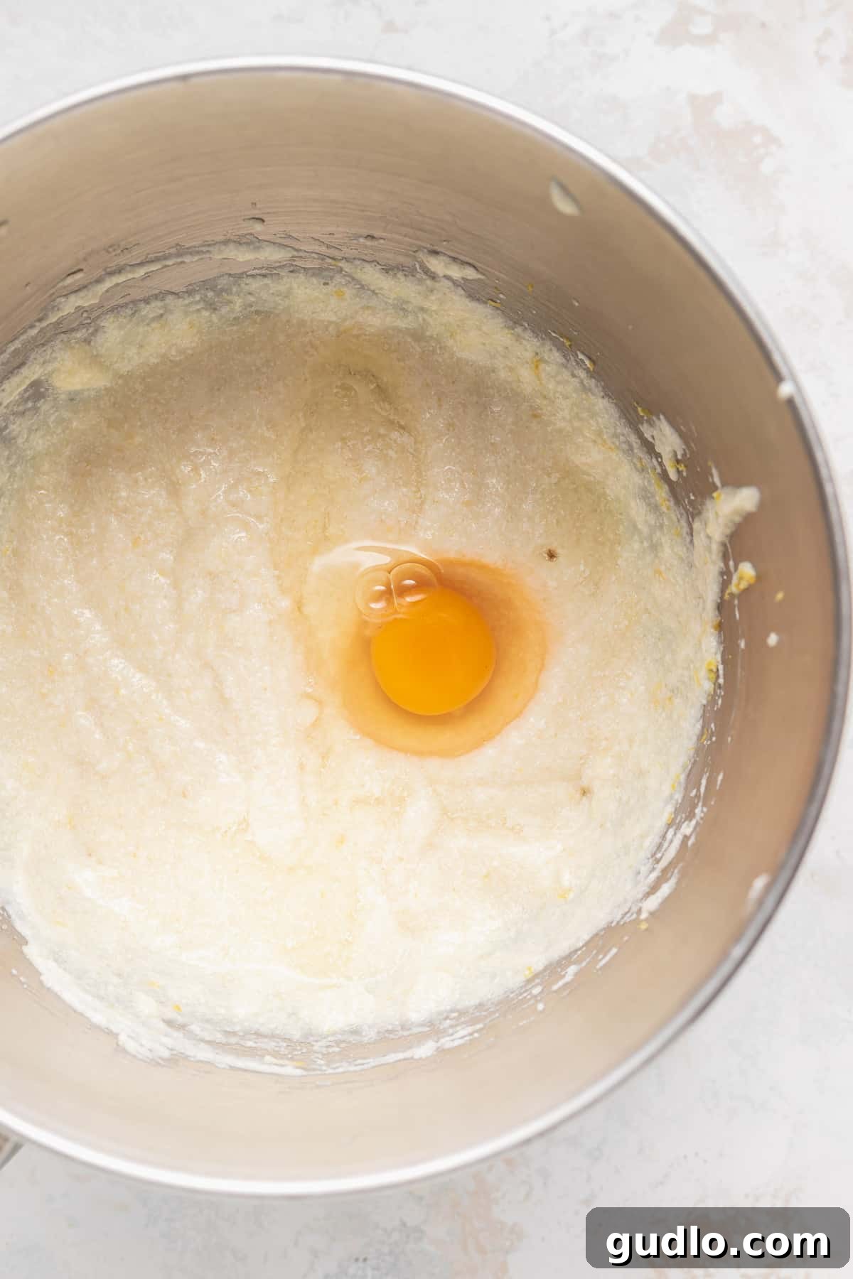 Make any occasion special with this deliciously fluffy and moist lemon ricotta cake that's made from 9 simple ingredients. Enjoy! Wet ingredients for lemon ricotta cake being mixed in a large mixing bowl