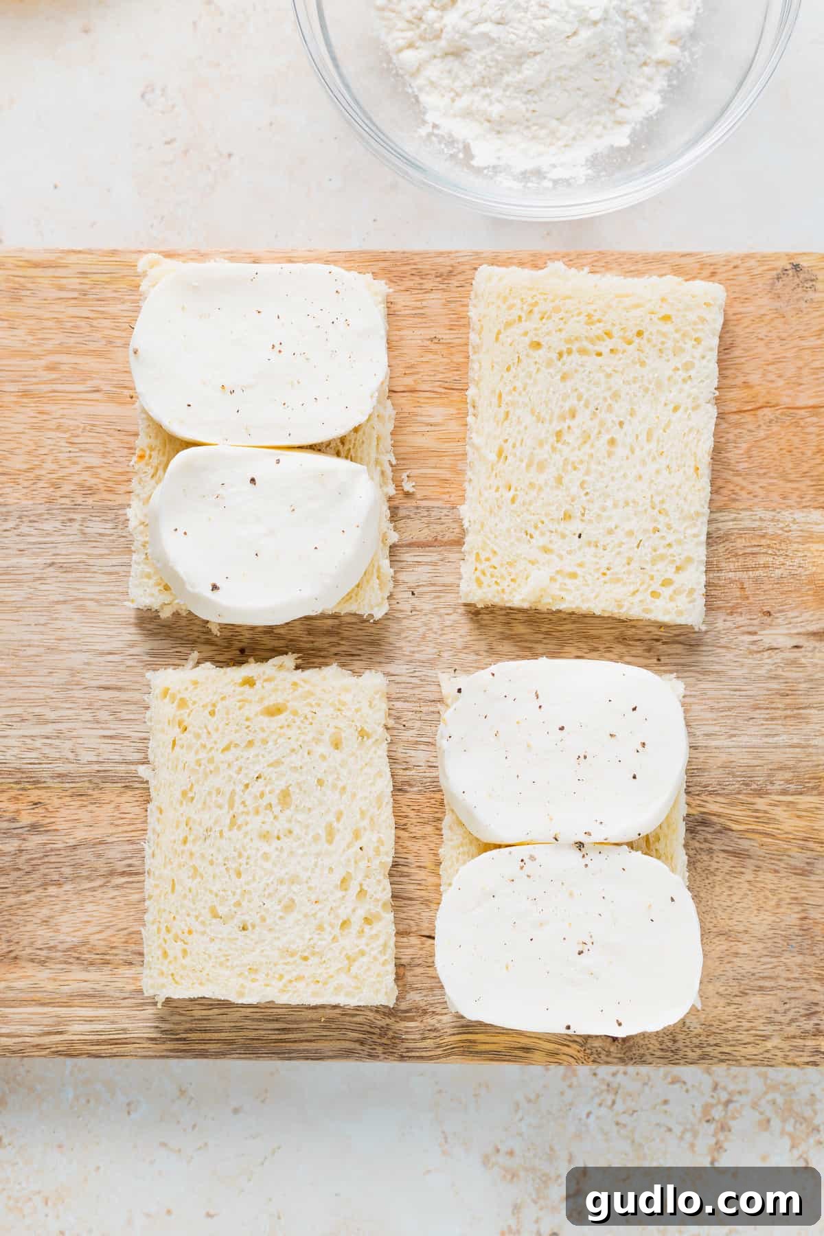 Fresh mozzarella slices on bread for sandwich assembly Slices of fresh mozzarella arranged on white bread, ready to be assembled into Mozzarella in Carrozza