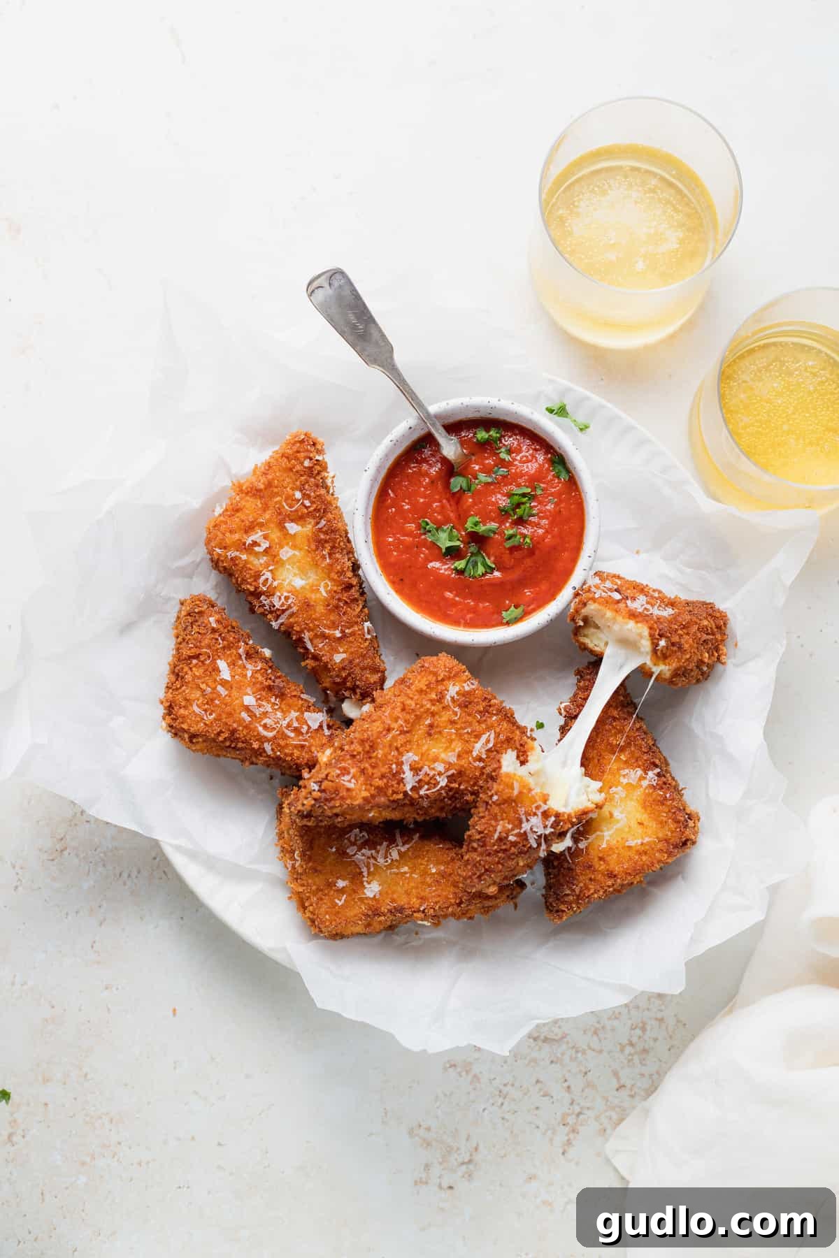Ready-to-serve Mozzarella in Carrozza with marinara Platter of fried Mozzarella in Carrozza sandwich triangles with a bowl of marinara dipping sauce