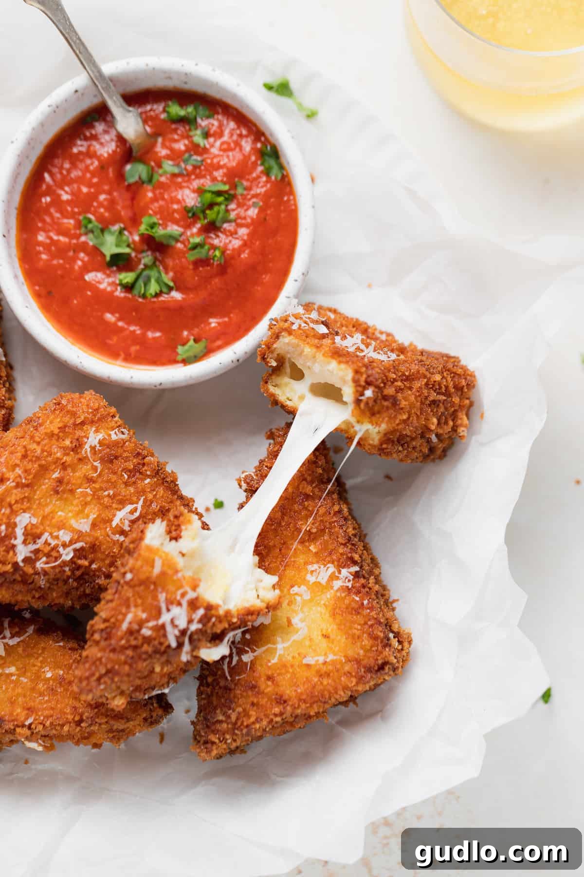 The irresistible pull of melted mozzarella Stringy, melted mozzarella cheese stretching from a broken Mozzarella in Carrozza sandwich triangle