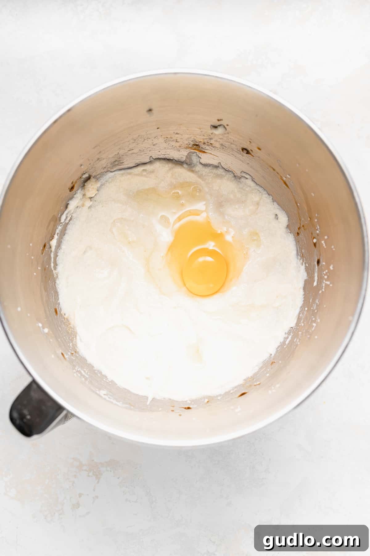 Mixing Wet Ingredients for Ricotta Muffins Wet ingredients for chocolate chip ricotta muffins being mixed in a bowl, showing a creamy, inviting texture.