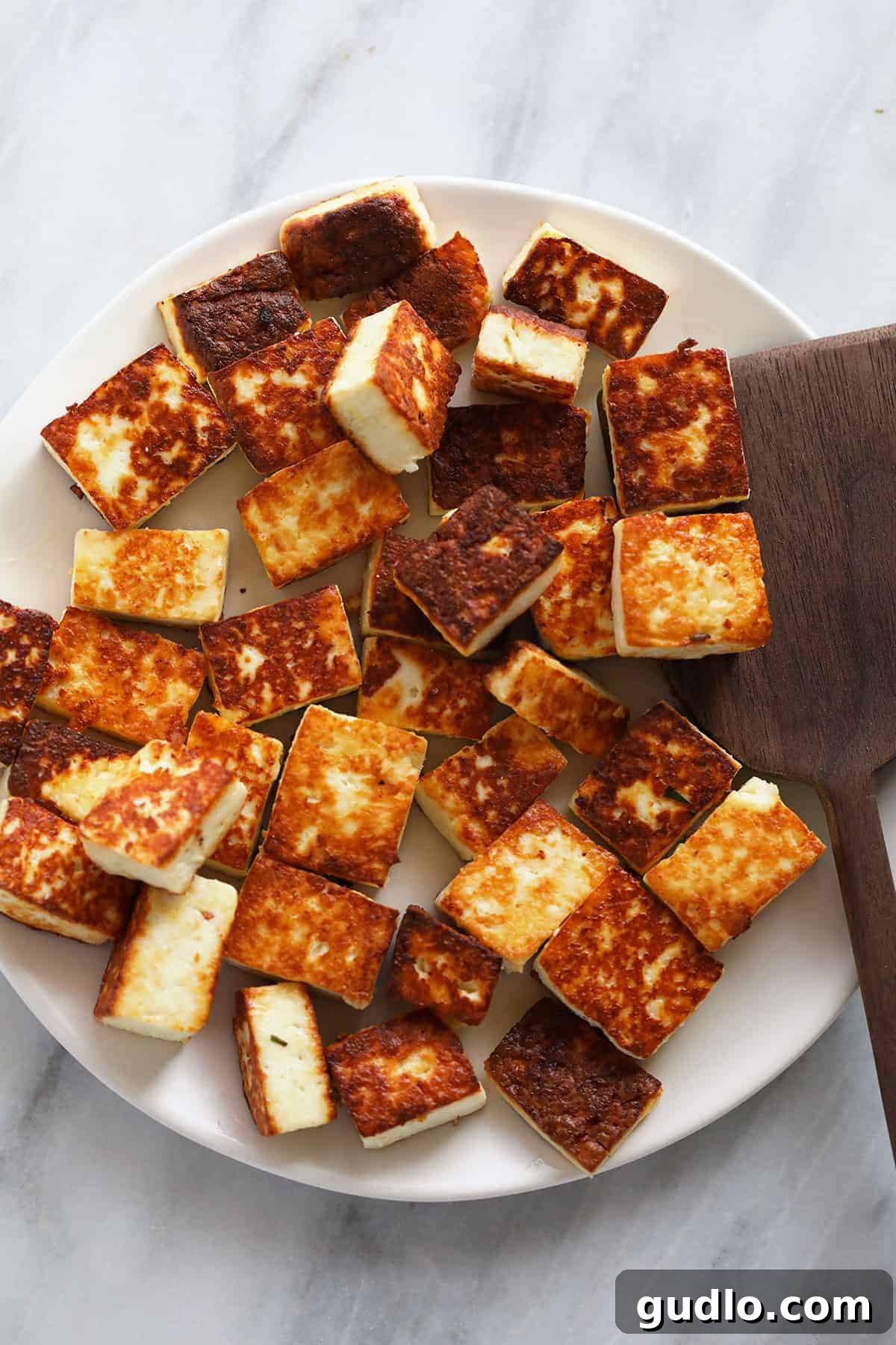 Emerald Spinach and Cottage Cheese Delight 5 Perfectly browned paneer cubes neatly arranged on a plate, ready to be added to the rich curry sauce.