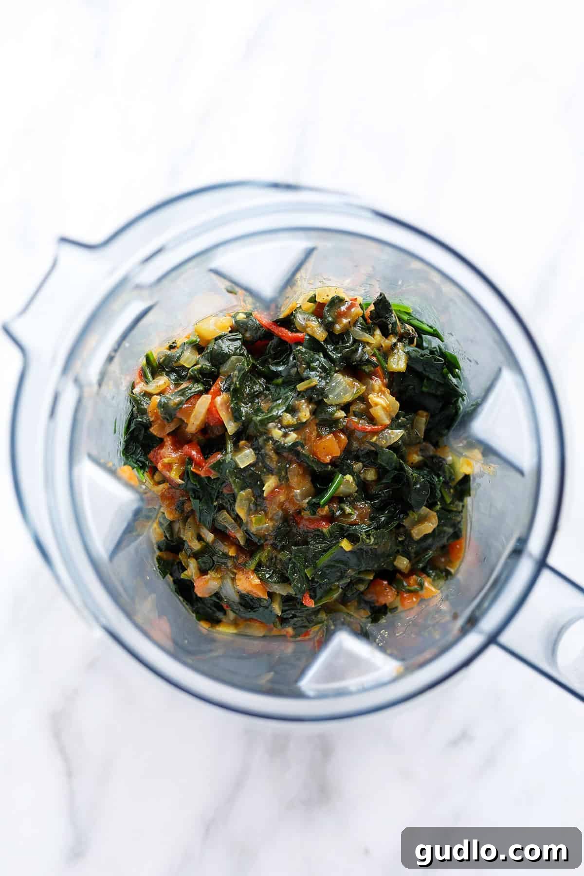 Emerald Spinach and Cottage Cheese Delight 8 The cooled spinach and vegetable mixture being transferred into a high-powered blender, ready to be pureed into a smooth curry base.