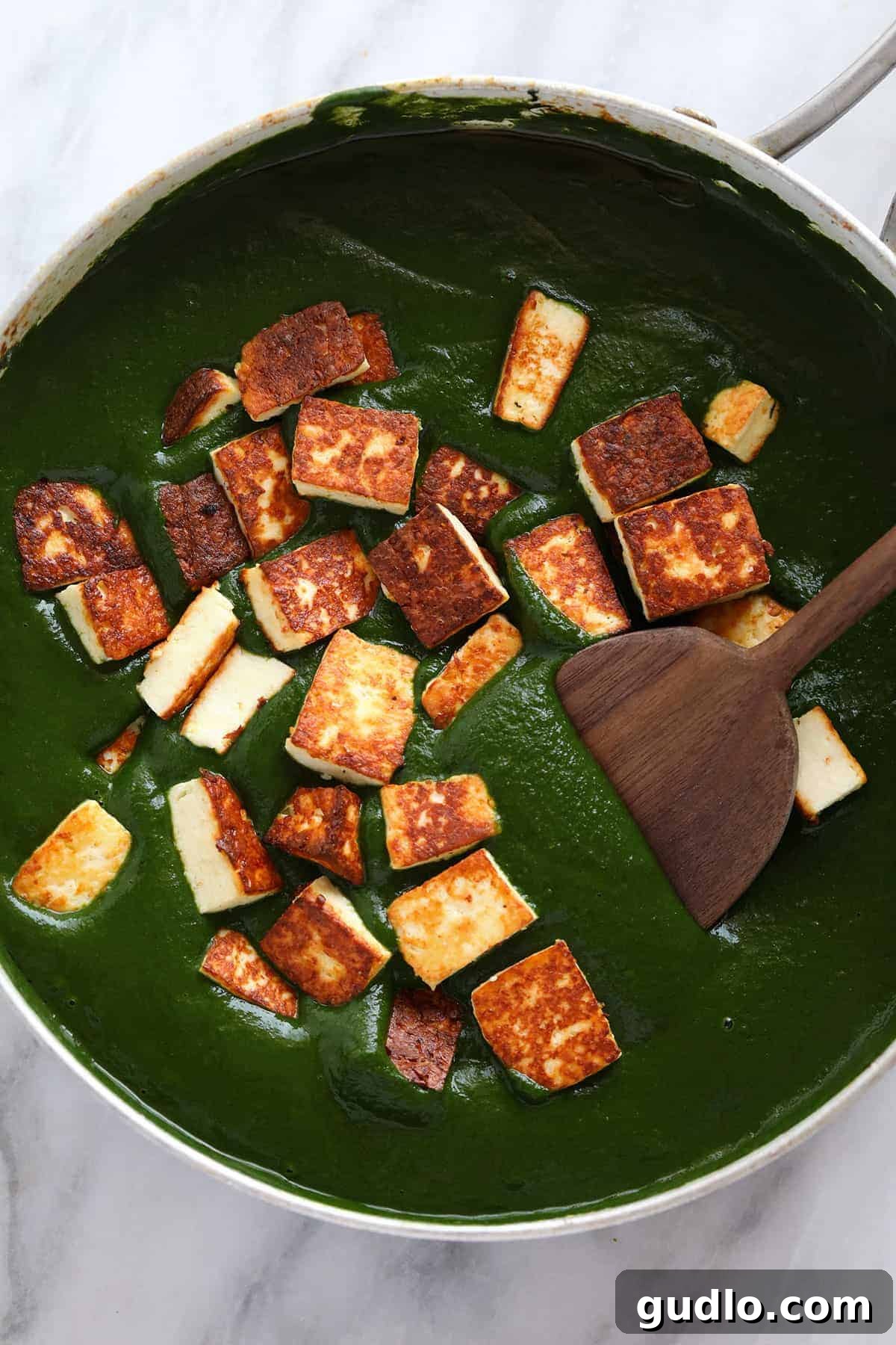 Emerald Spinach and Cottage Cheese Delight 10 The golden-brown paneer cubes gracefully folded into the simmering, rich green spinach curry sauce.