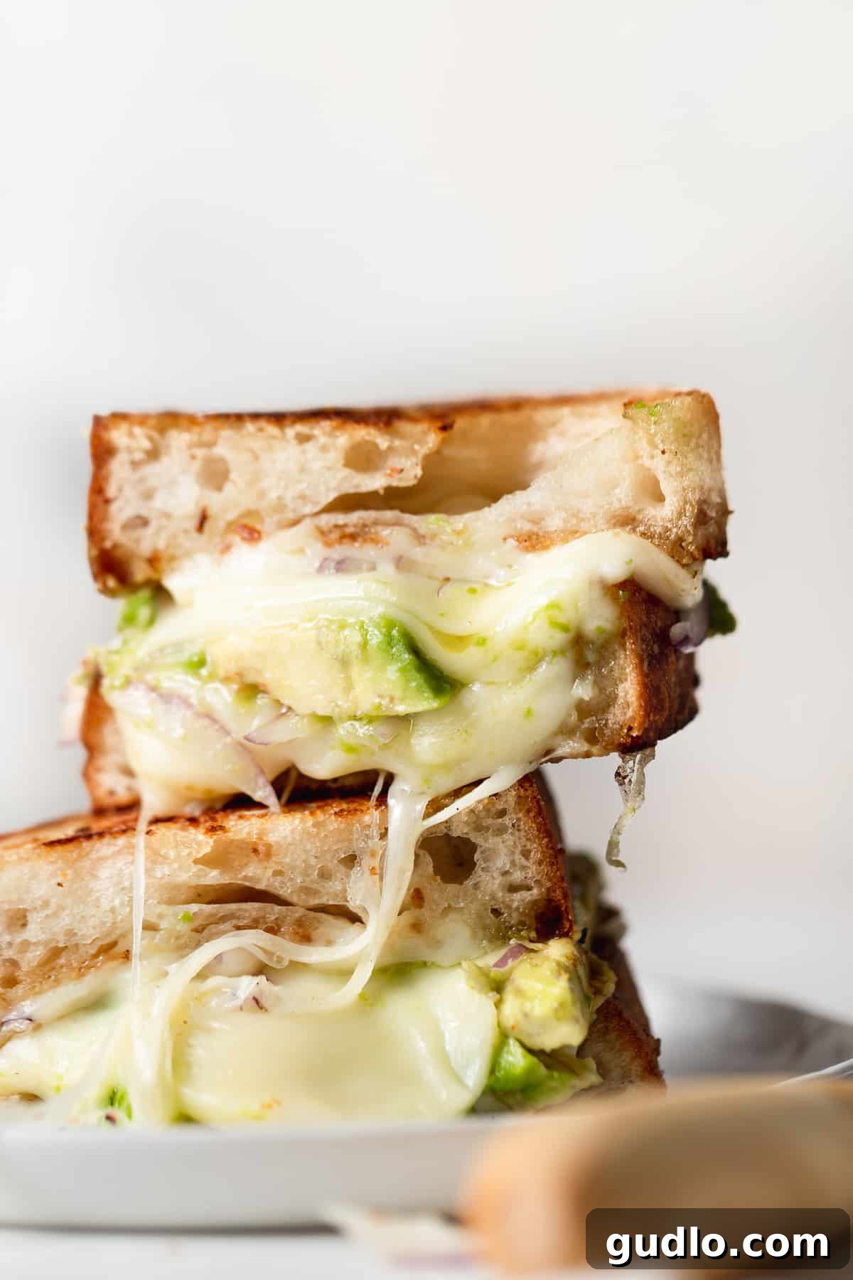 Ultimate Avocado Grilled Cheese: Creamy, Cheesy, and Delicious Stacked avocado grilled cheese sandwiches, showcasing melted cheese and fresh avocado slices.