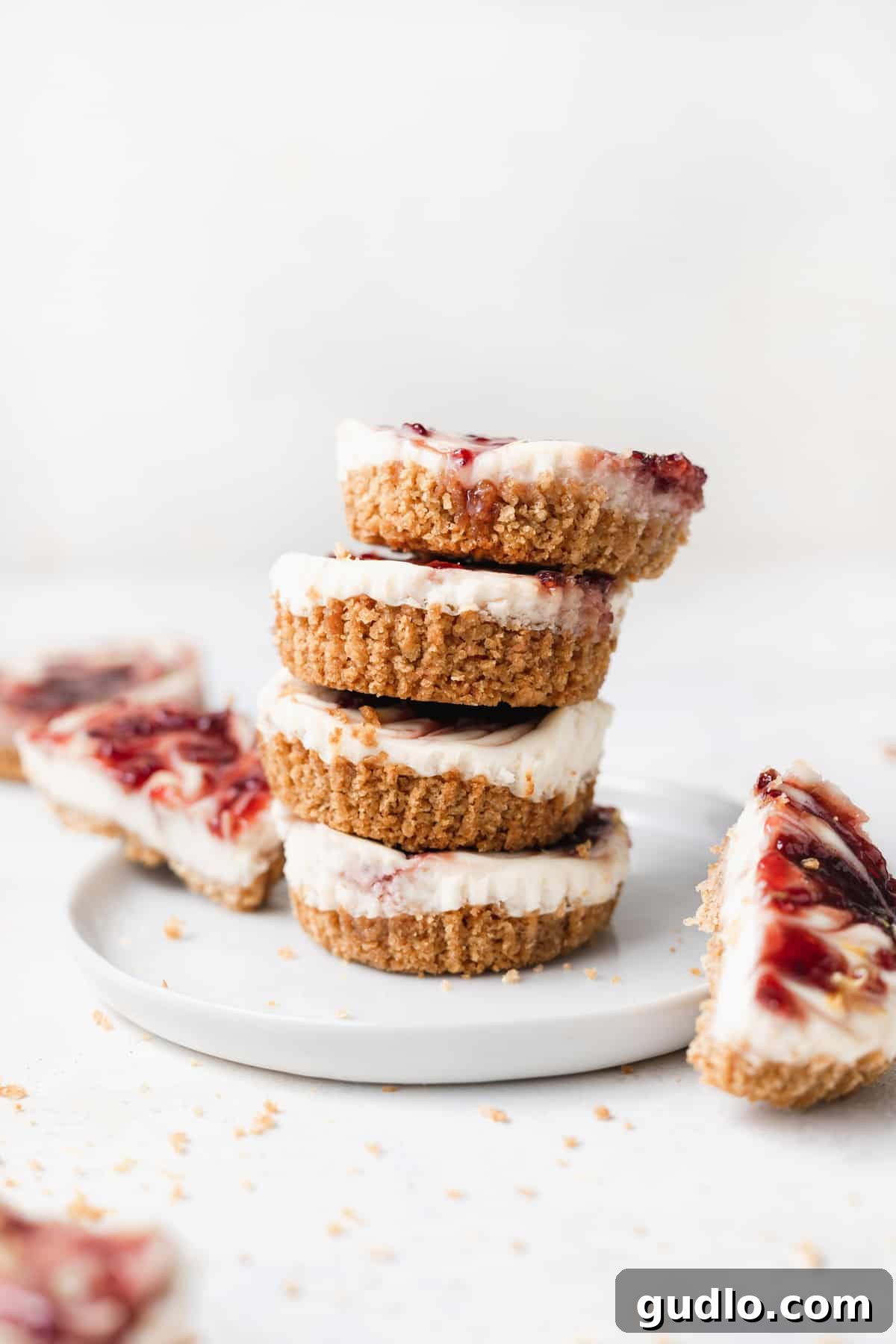 Bite-Sized Cheesecake Delights 6 A stack of perfectly portioned lemon raspberry cheesecake bites on a small plate.