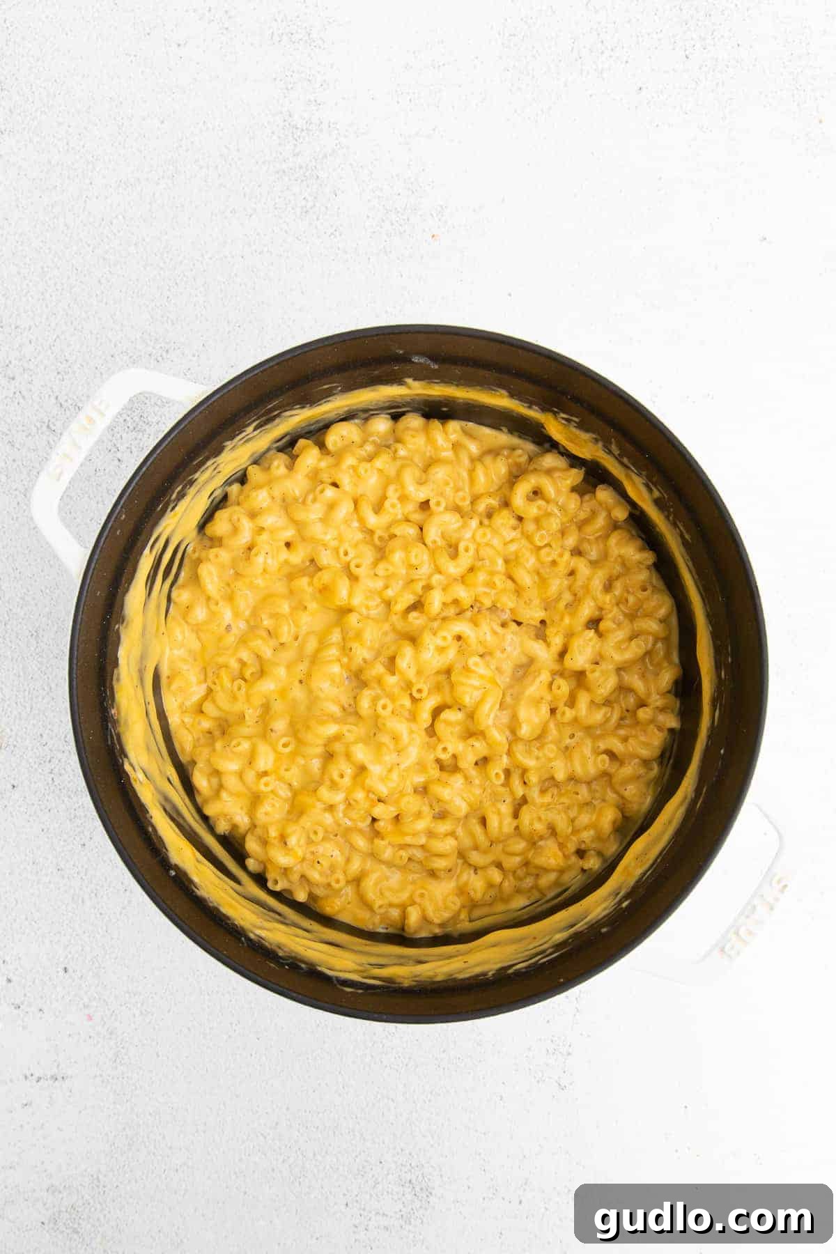 A large pot of perfectly creamy and thick mac and cheese, ready to be served.