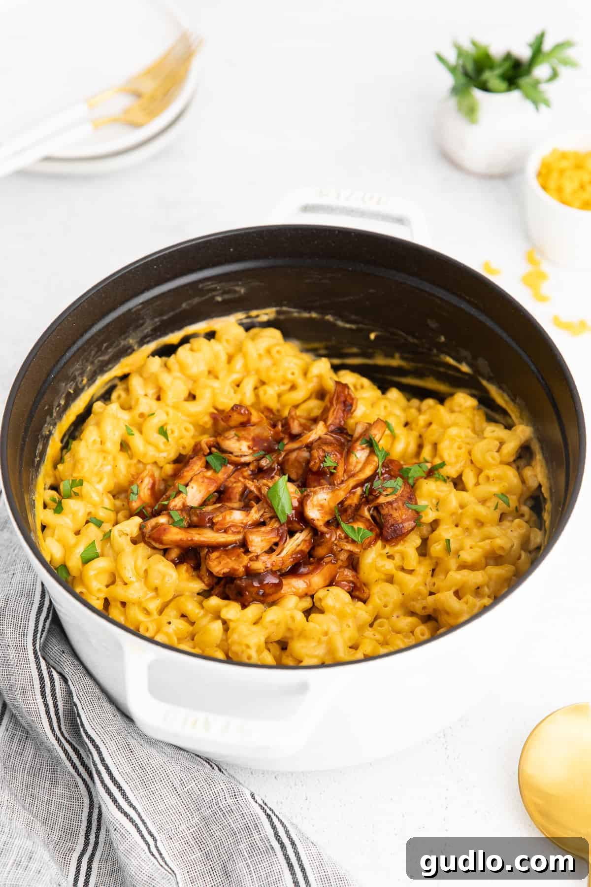 BBQ chicken mac and cheese simmering in a large pot, showcasing the rich sauce and tender pasta.