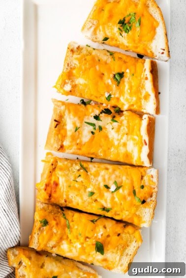 Golden Cheesy Garlic Bliss 14 Cheesy garlic bread on plate.