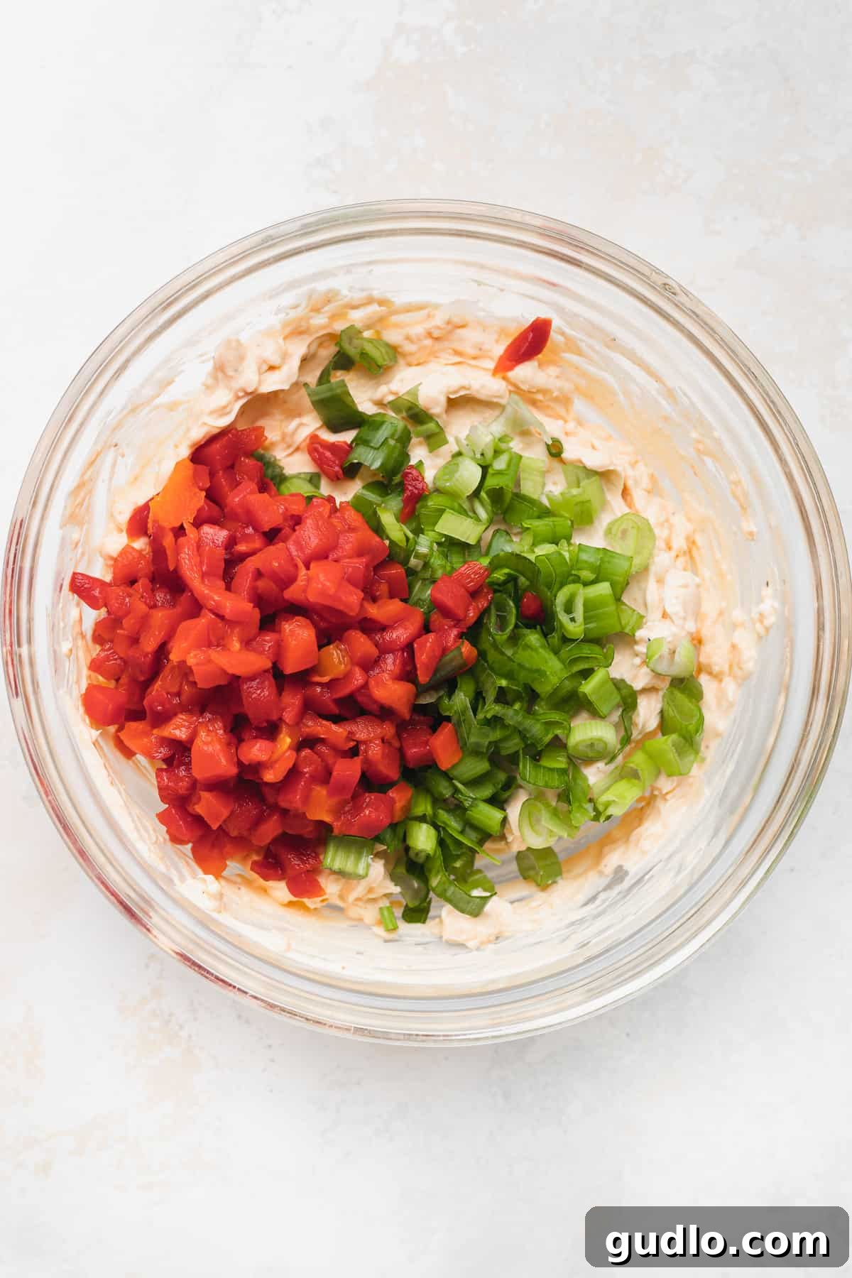 Make your own homemade pimento cheese for a decadent spread or easy dip for crackers. Enjoy! pimento cheese with pimentos and green onion in bowl
