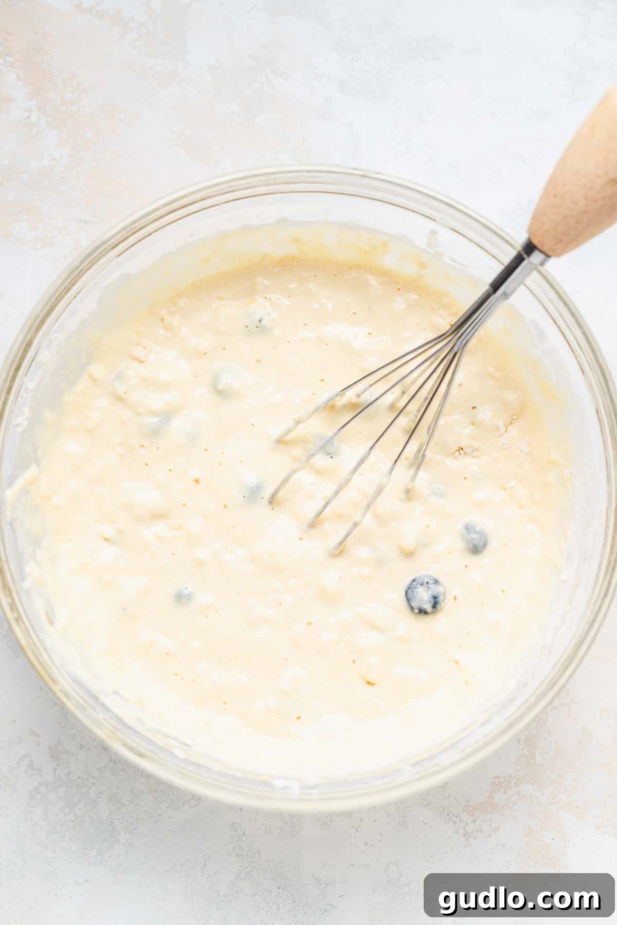 Fluffy pancake batter being whisked in a bowl
