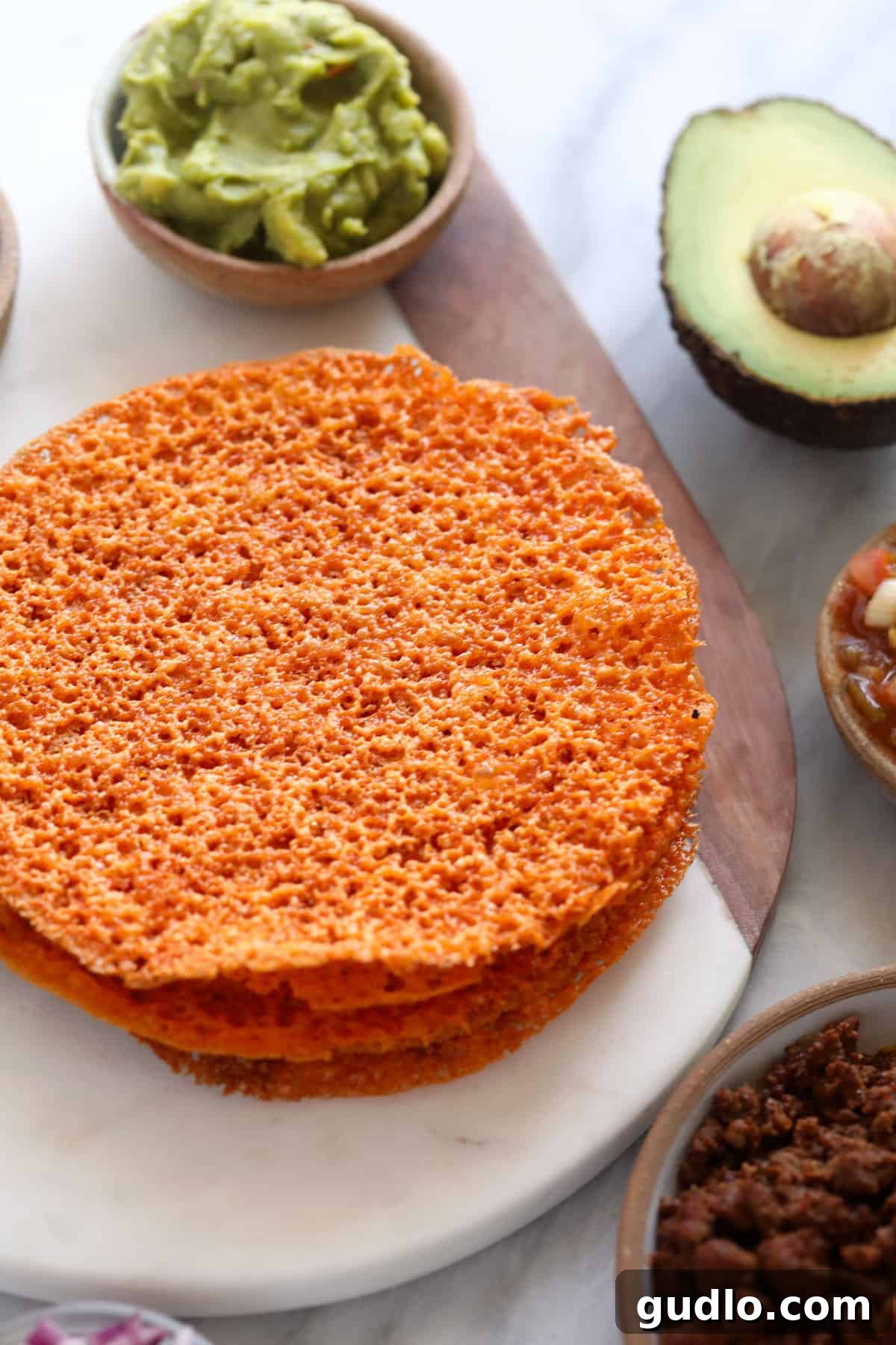 A stack of cheese tortillas surrounded by avocados and salsa, illustrating meal potential.