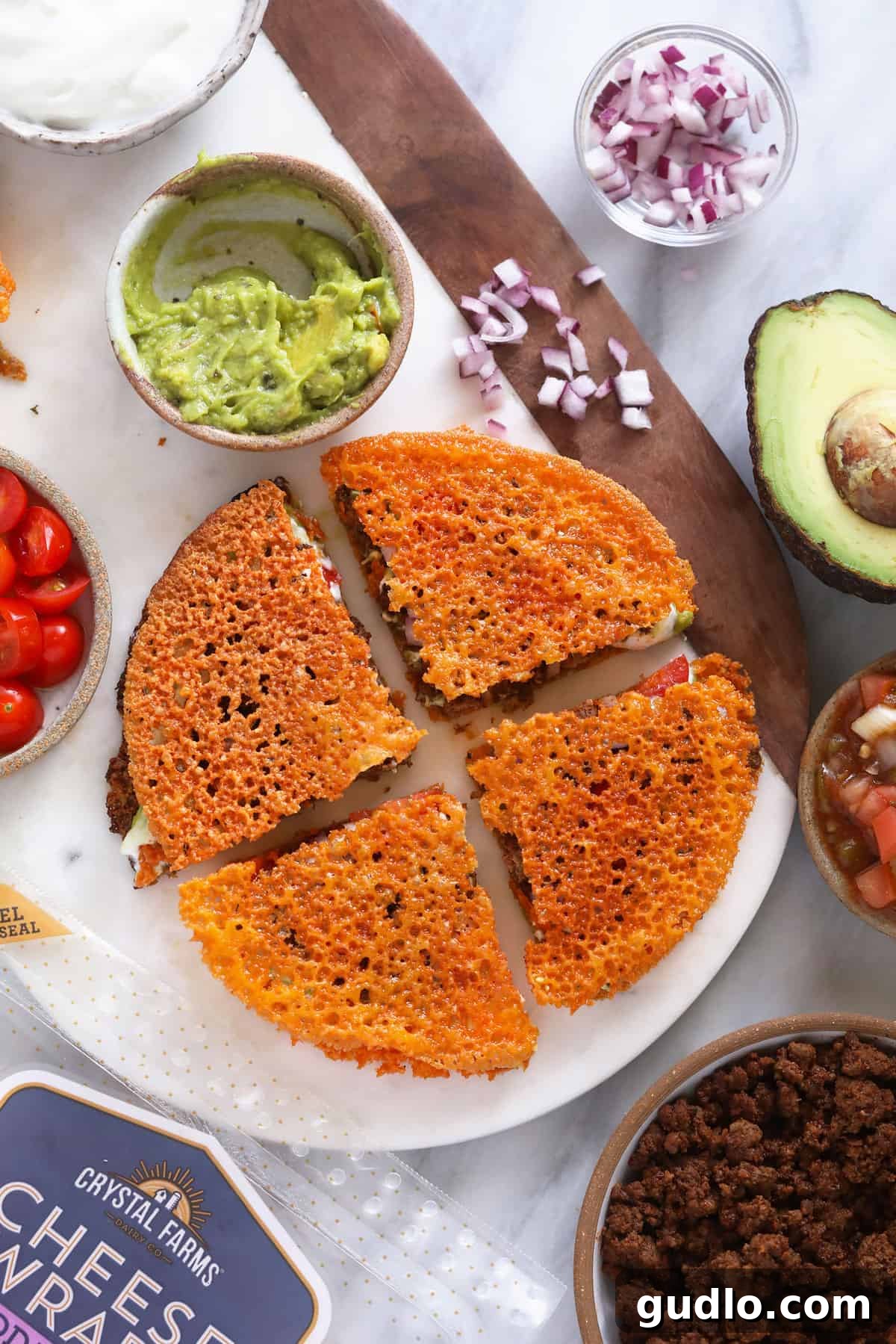 A freshly cut keto quesadilla resting on a rustic cutting board, highlighting its crispy cheese exterior and bountiful internal fillings, perfect for an easy meal.