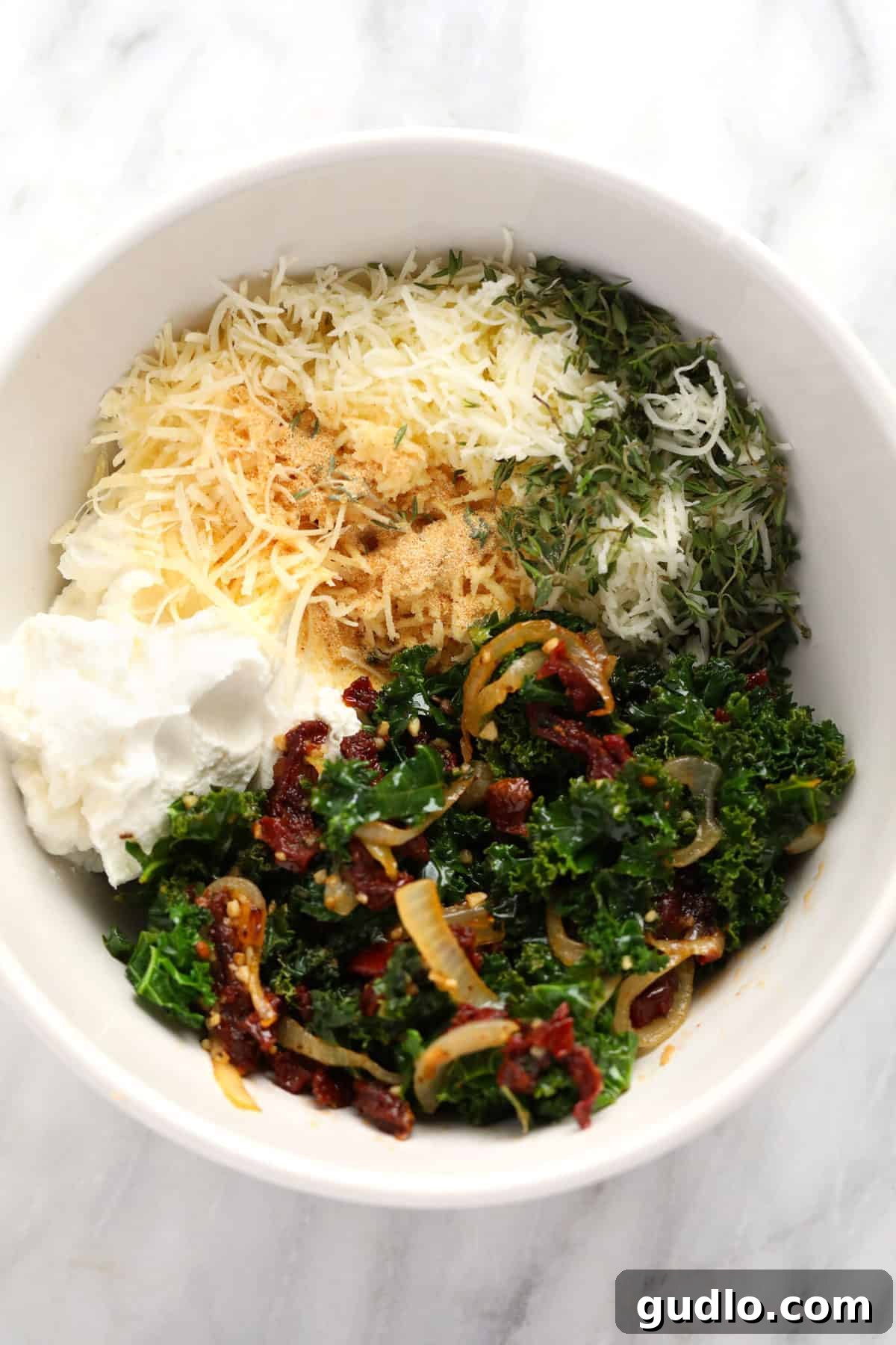 Wholesome Kale Lasagna Roll Ups 4 A bowl filled with all the vibrant ingredients for Kale Lasagna Roll Ups, ready to be mixed.