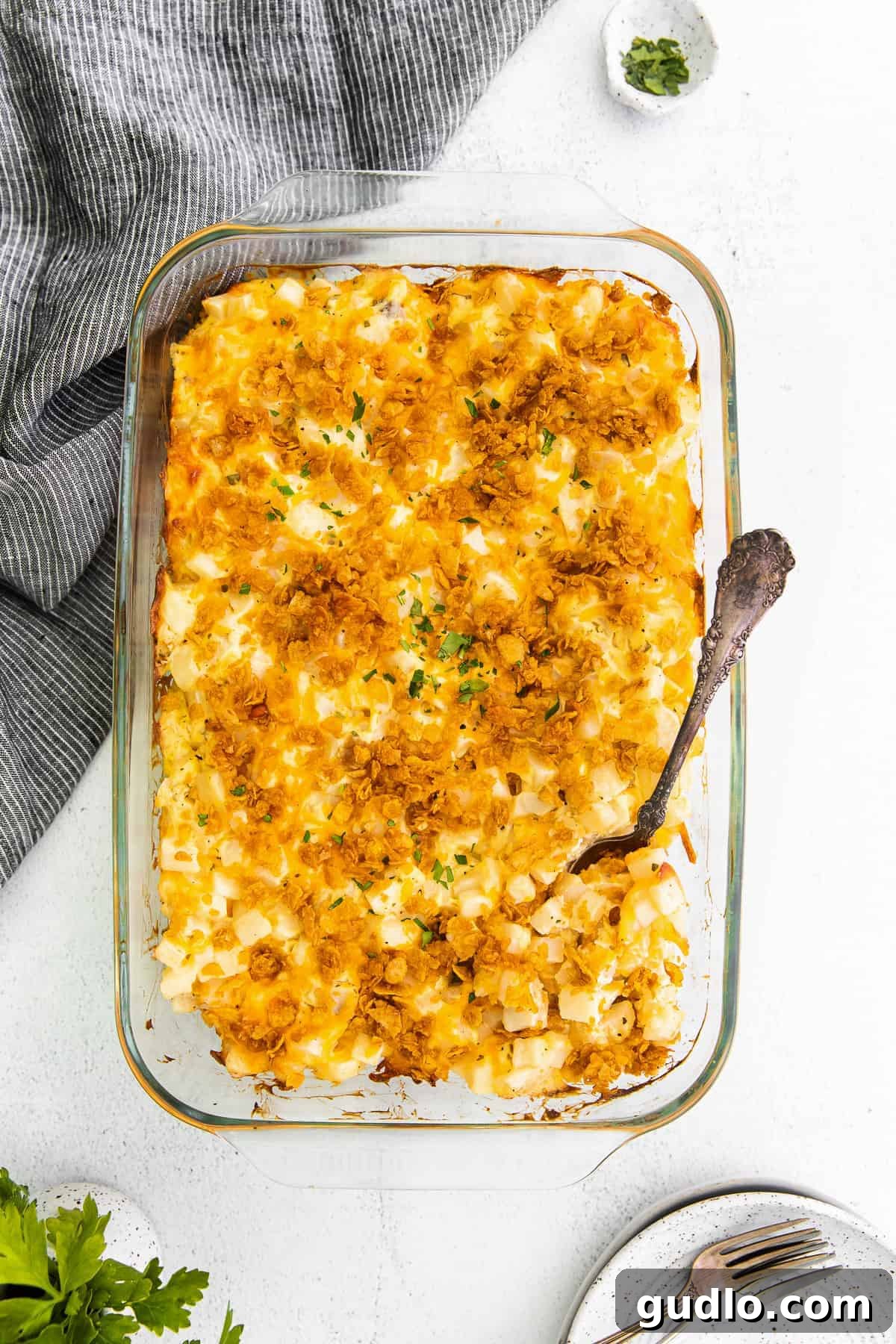 Ultimate Cheesy Hashbrown Potatoes: The Best Holiday Side Cheesy potato hashbrowns in casserole dish, golden brown and bubbly.