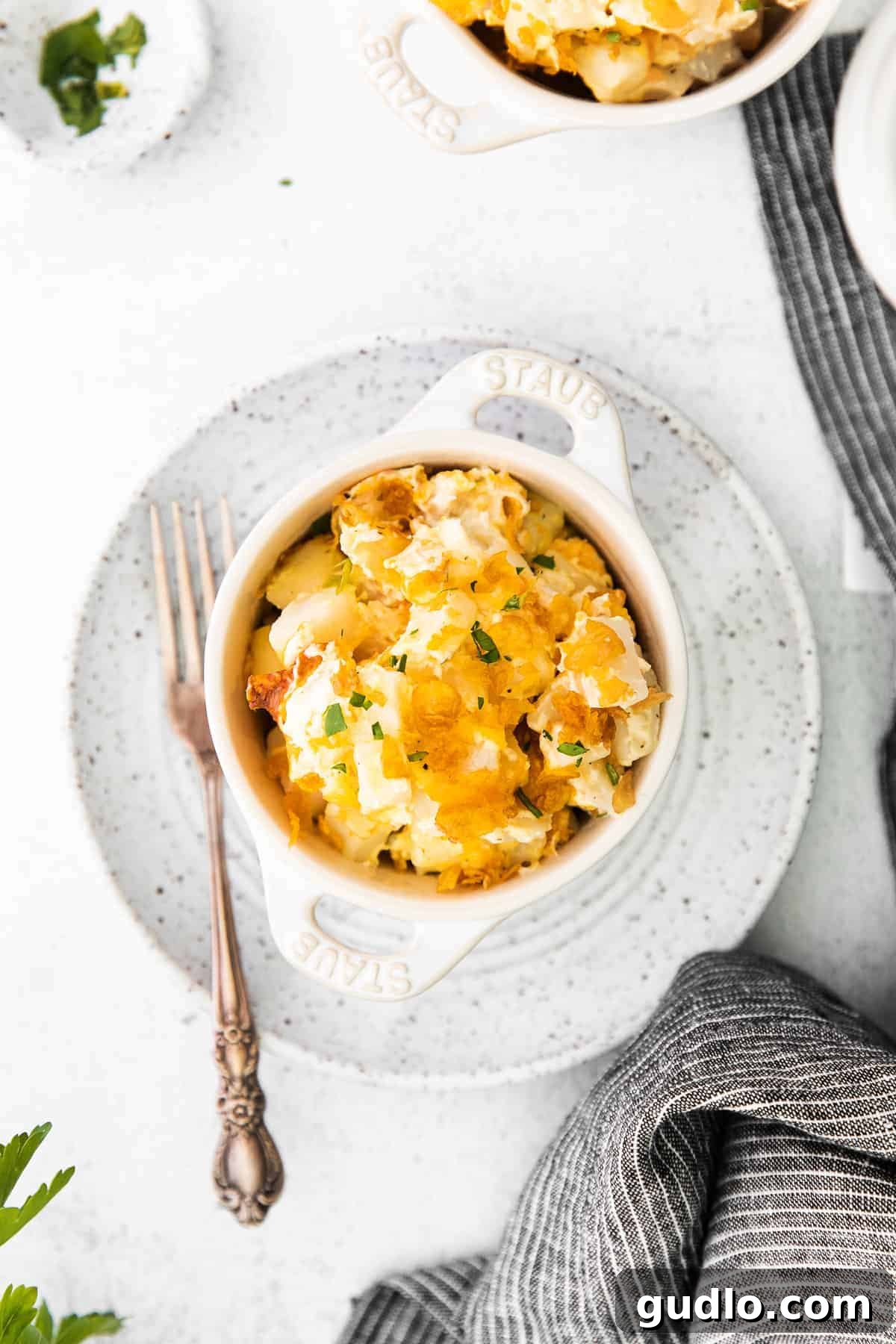 Serving Cheesy Hashbrown Casserole Scoop of cheesy hashbrowns in a bowl, showing creamy texture and melted cheese.