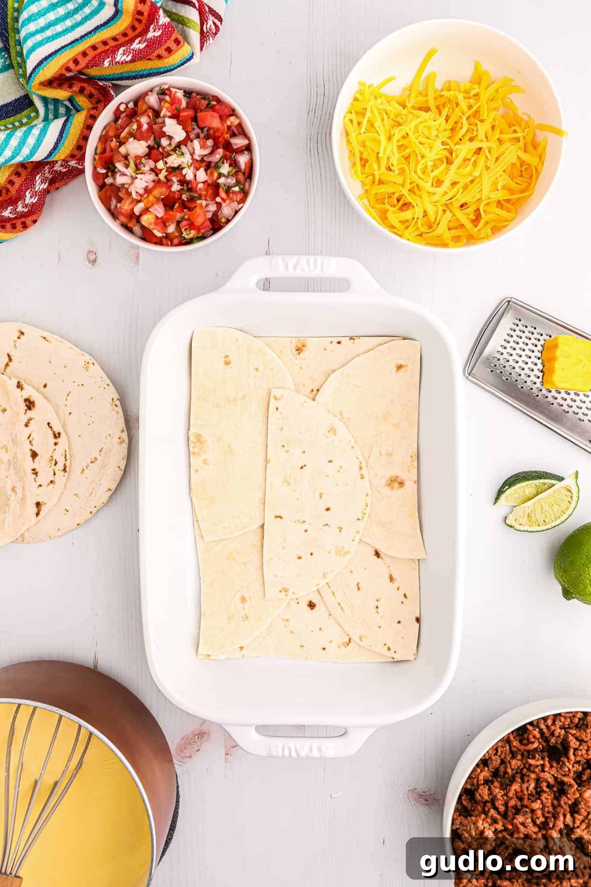 Tex-Mex Lasagna 6 A casserole dish with flour tortillas perfectly laid out on the bottom, forming the first layer of the taco lasagna.