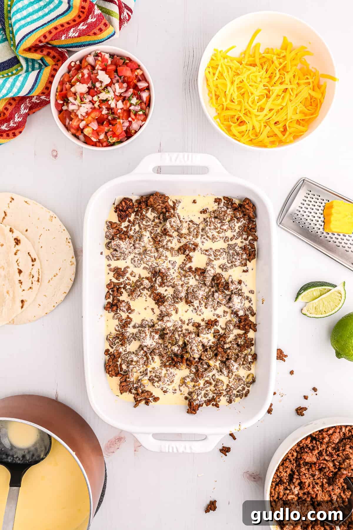 Tex-Mex Lasagna 7 A casserole dish filled with layers of ground beef and cheese sauce, showing the delicious progression of the taco lasagna.