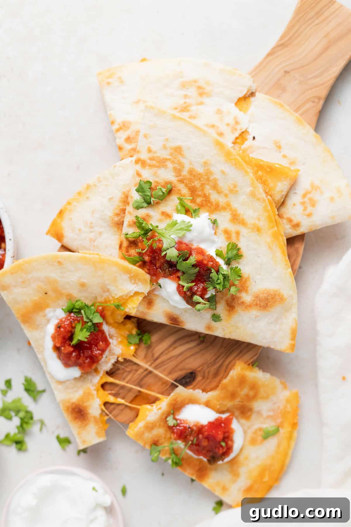 Easy Cheese Quesadilla Recipe: Golden, Gooey, and Delicious Perfectly cooked golden-brown cheese quesadilla on a wooden cutting board, ready to be sliced.