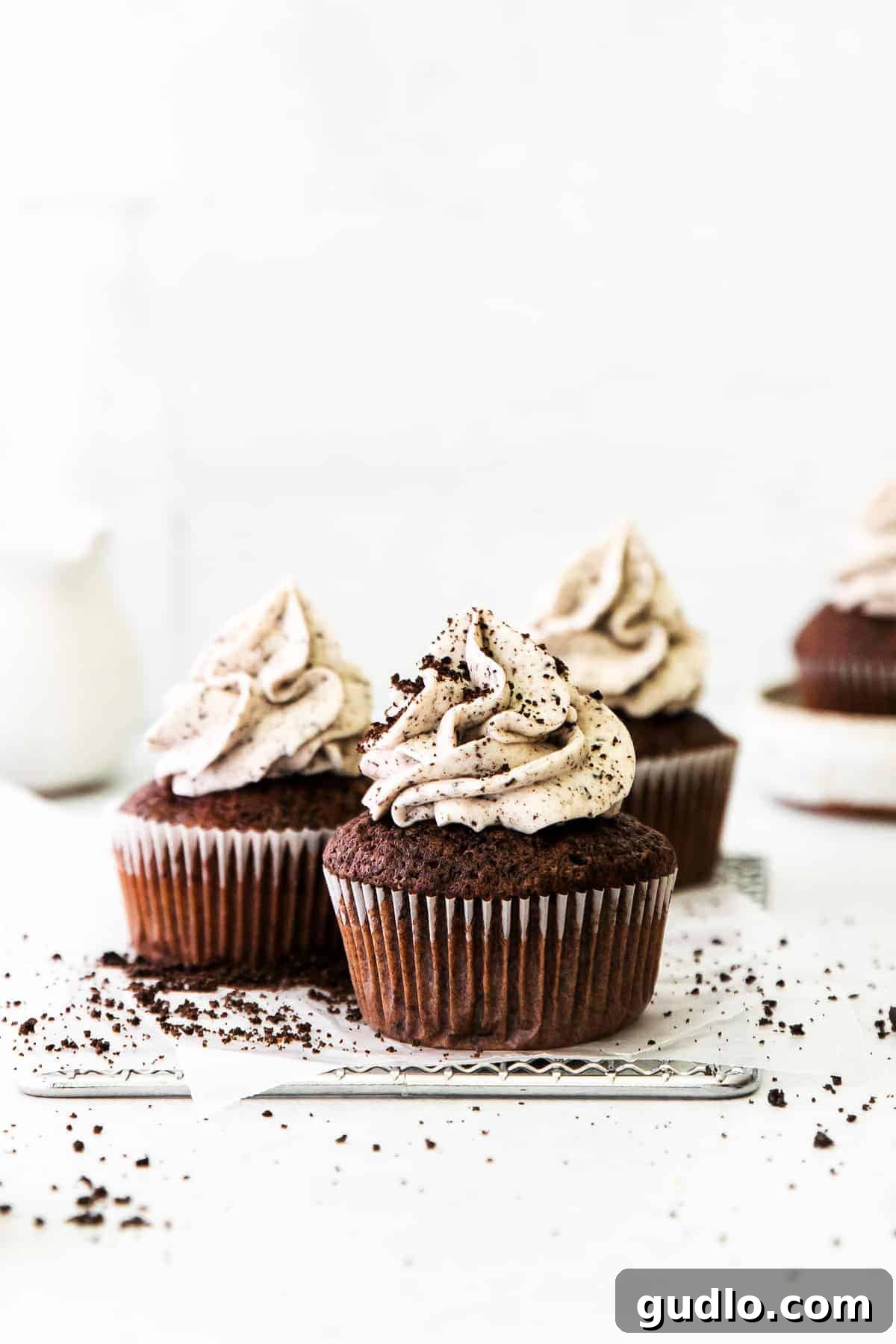 Delicious cookies and cream cupcakes arranged on a wire rack, ready to be enjoyed.