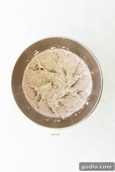 A metal bowl containing powdered sugar, ready for frosting preparation.