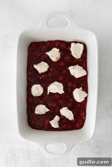 Cherry Cream Cheese Cloud Cake 6 a dessert with cranberry sauce and whipped cream.