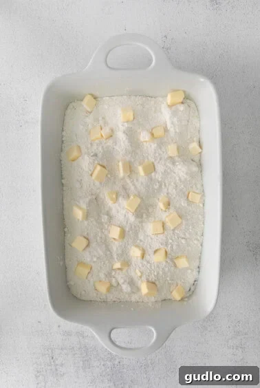 Cherry Cream Cheese Cloud Cake 7 a cream cheese cherry dump cake served in a white baking dish.
